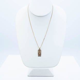 14K GOLD "EGYPTIAN" PENDANT AND CHAIN: Elegant 14K yellow gold Egyptian style cartouche pendant having hieroglyphics and a textured finish suspended from a 14K gold diamond cut curb chain. 15.5" and 4.9 grams.