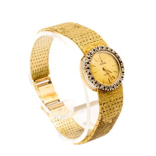 14K GOLD AND DIAMOND LADIES WATCH: Concord, Switzerland late 20th century 14K yellow gold case and14K gold band having a round watch face encircled with diamonds. 38.2 grams total weight. Mechanical movement and the hands move when wou