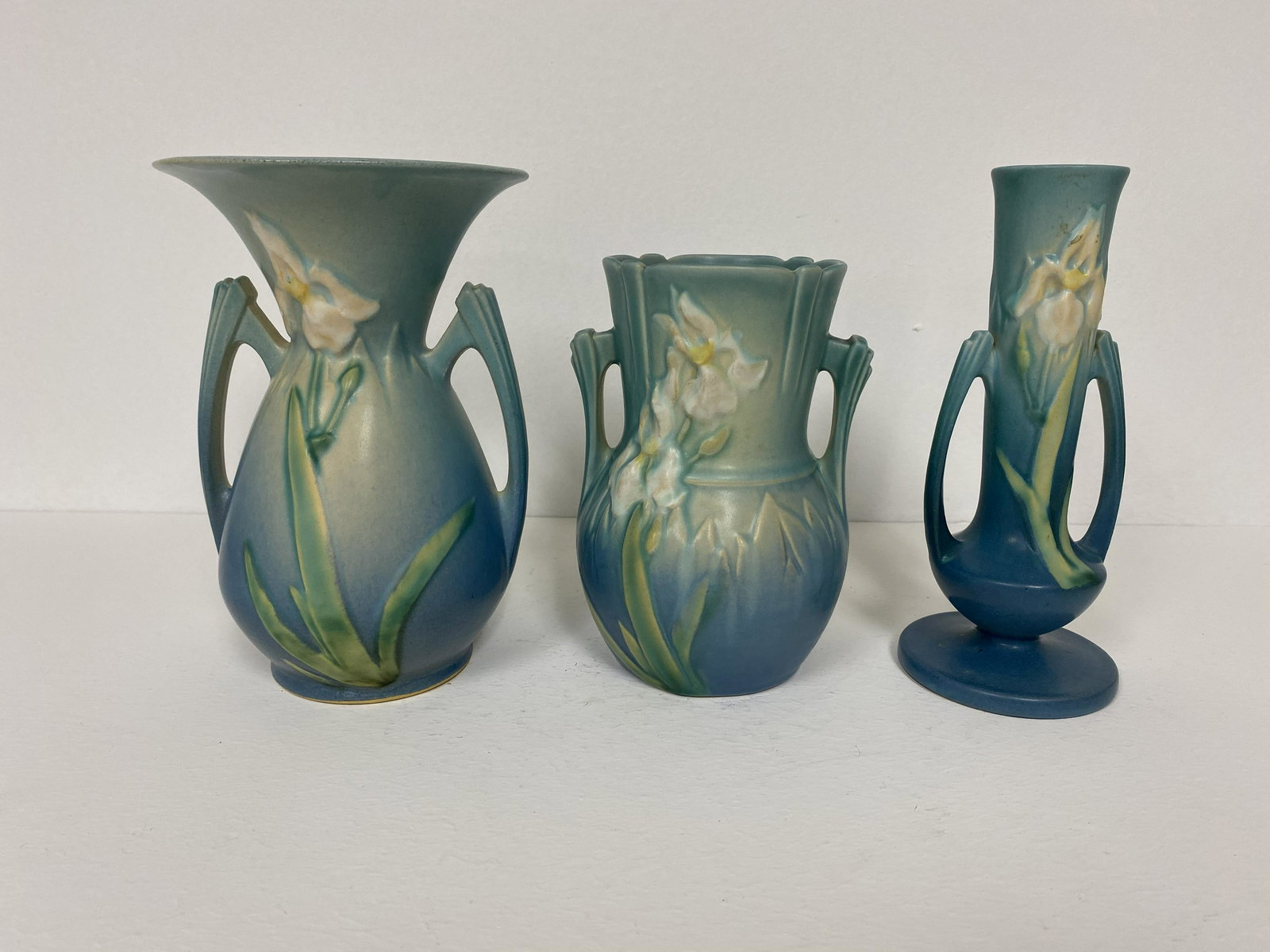 3 Roseville Pottery: Iris Blue 917-6, 920-7 918-7. Tallest 7 5/8".