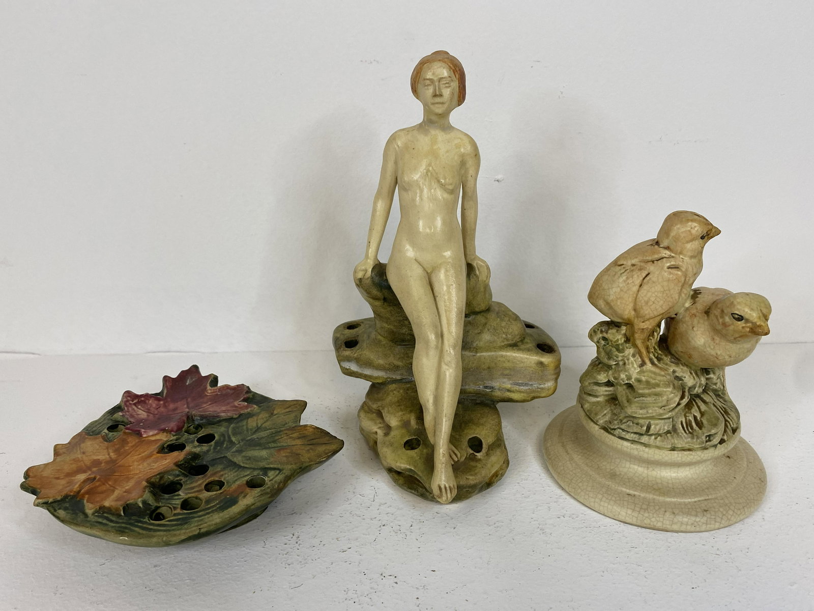 Weller Pottery: 3 Muskota pieces. 1 maple leaf 1 chicks and Leda leaning on rocks