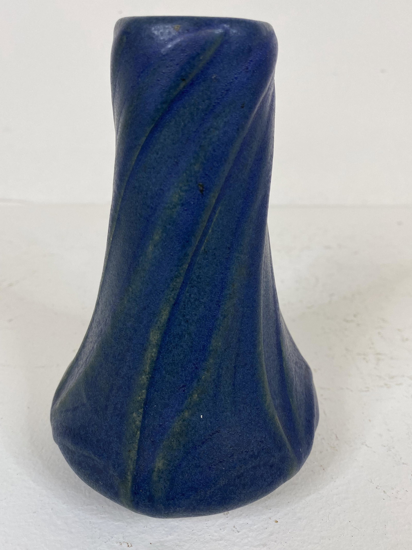 Van Briggle Pottery: 07-12 dates this sweet blue VB twisted design. Highlights of green underneath the rich blue glaze. 5 1/2" tall