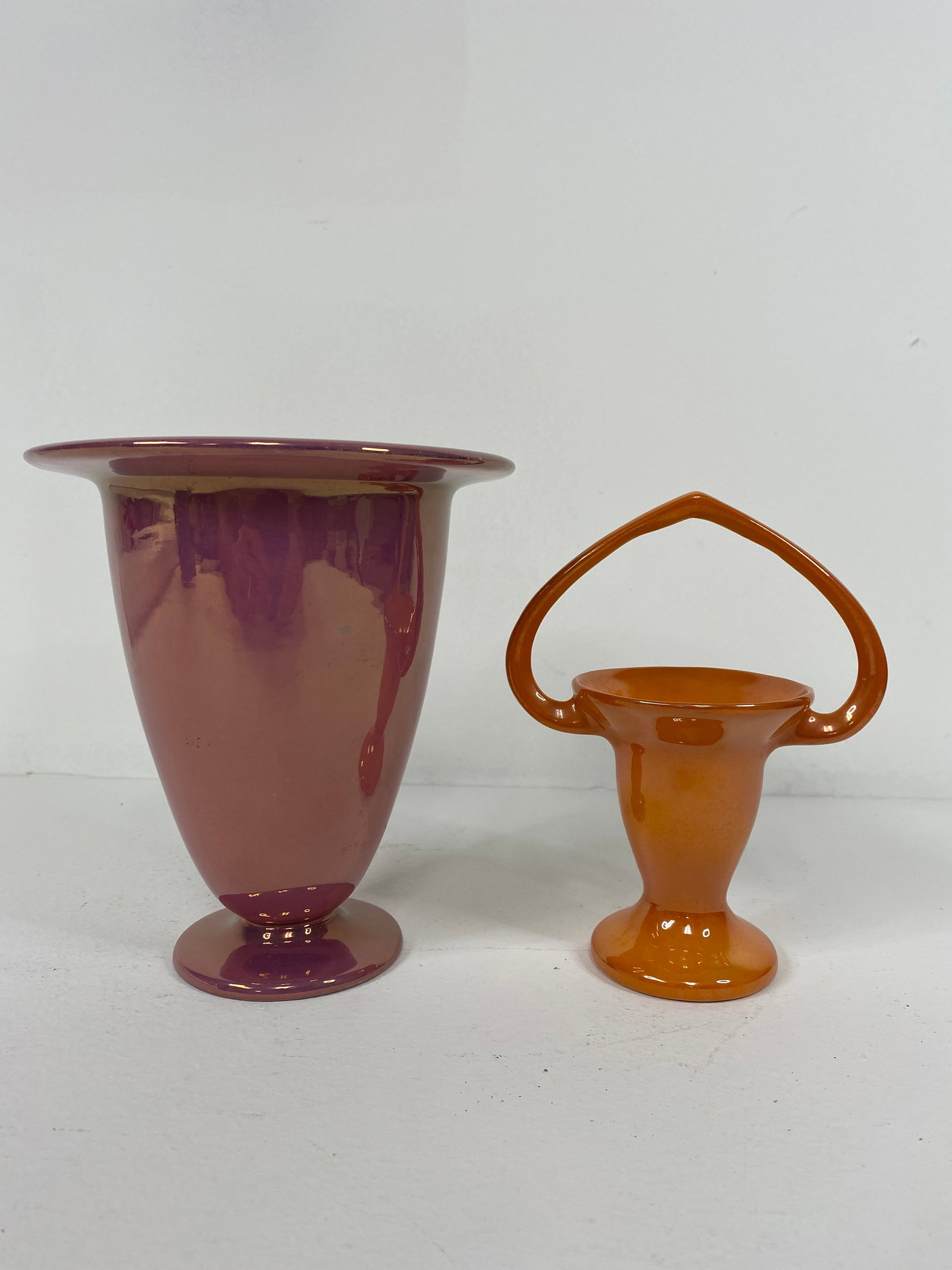 Roseville Pottery: 2 pieces of Luster , small basket in a rich Roange measuring 6 1/4" tall and the Pink vase measuring 6 1/2" tall
