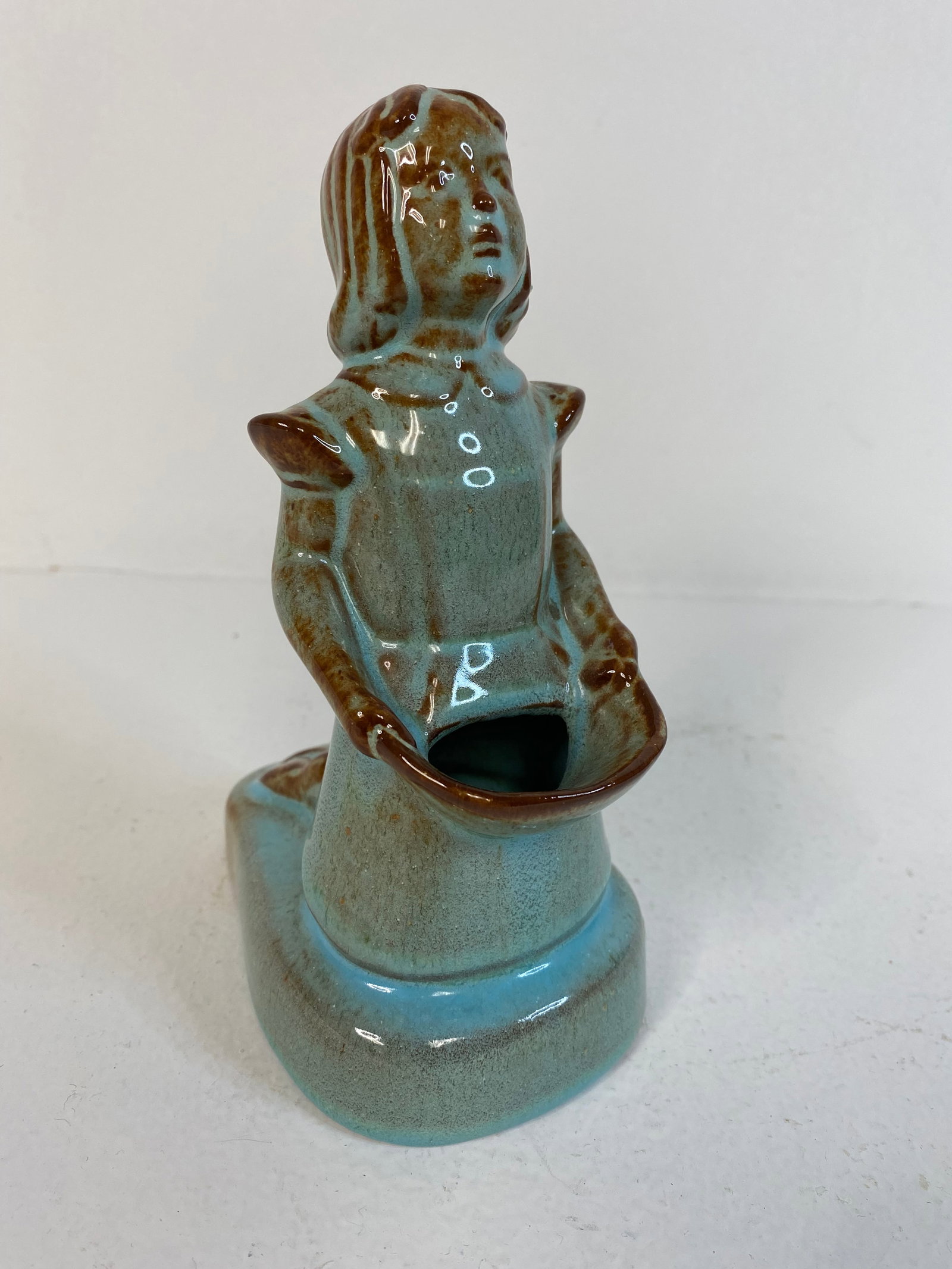 Nicodemus Pottery: Girl figural holding a basket. 6 1/2" tall