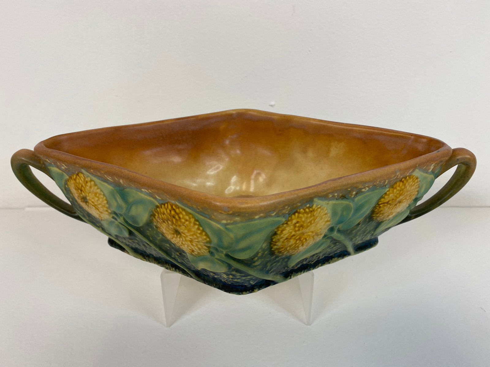 Roseville Pottery Sunflower #215: Very nice console bowl shape #215 and very nice mold and color. this console bowl measures 3 1/4" tall X 12 3/4" long.