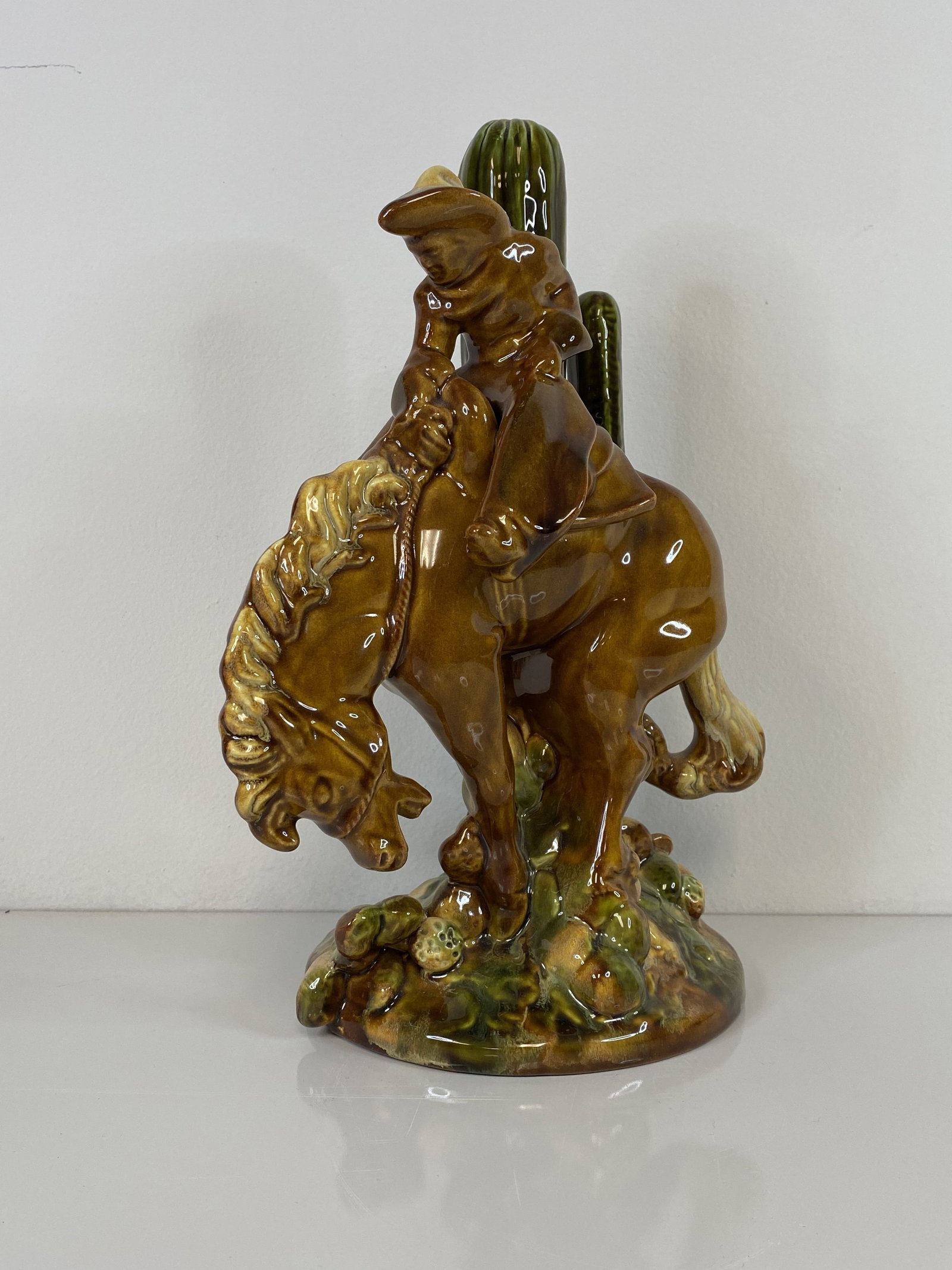 Royal Haeger Bucking Bronco: Featuring a cowboy on a bucking bronco with cactus in back. Measuring almost 13" tall