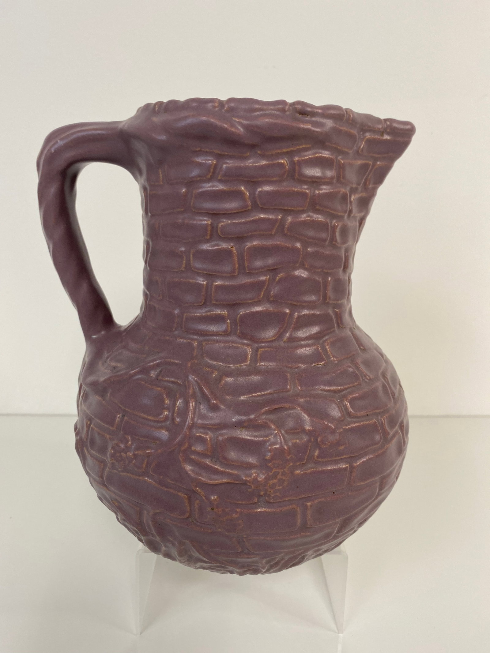 Zanesville Stoneware Vase: This pitcher features vine and berries going up a stone wall and measures slightly more than 8" tall