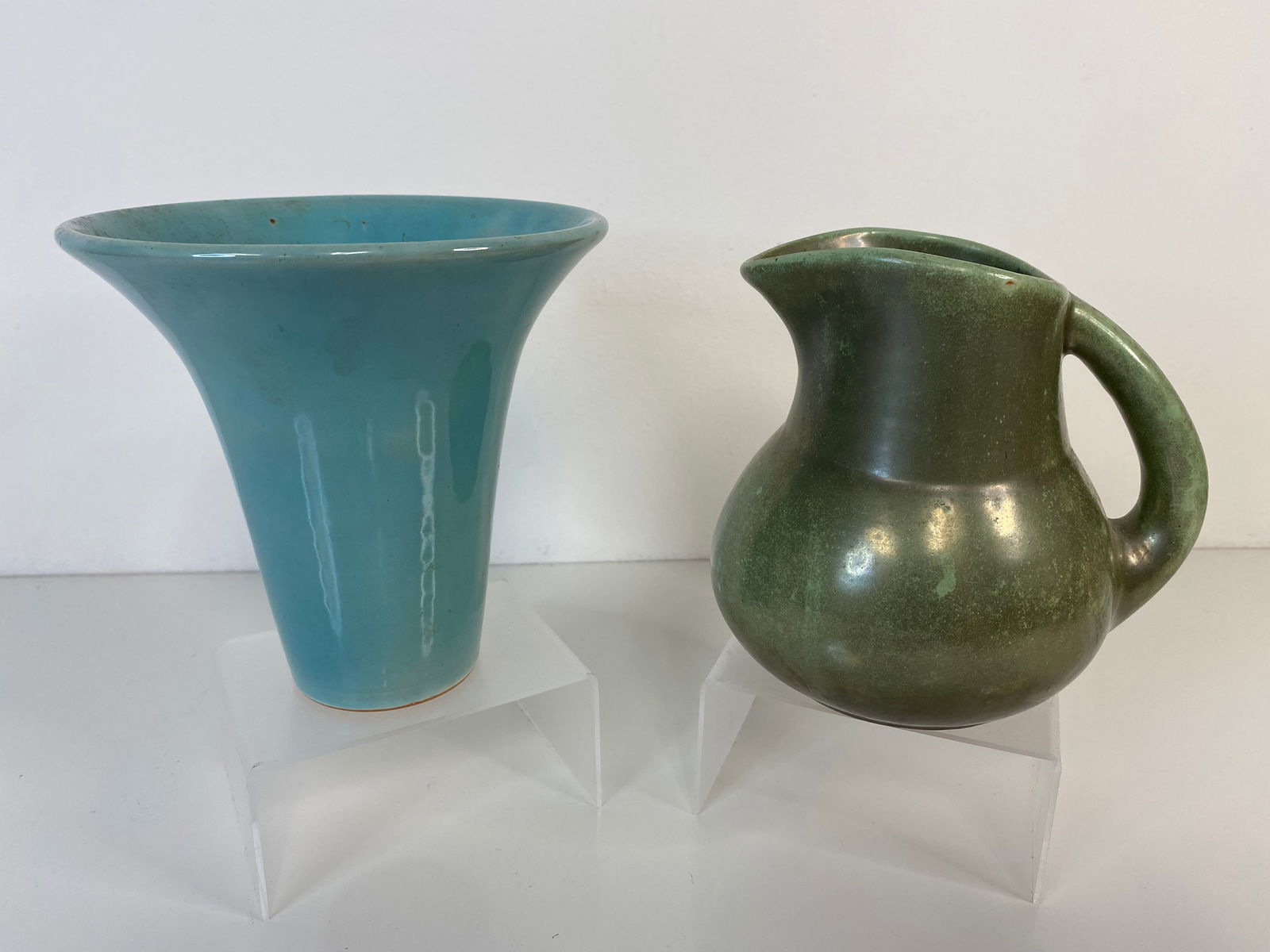 Shearwater Pottery lot: 2 pieces consisting of a blue vase at 5 1/2" tall and a gun metal green pitcher