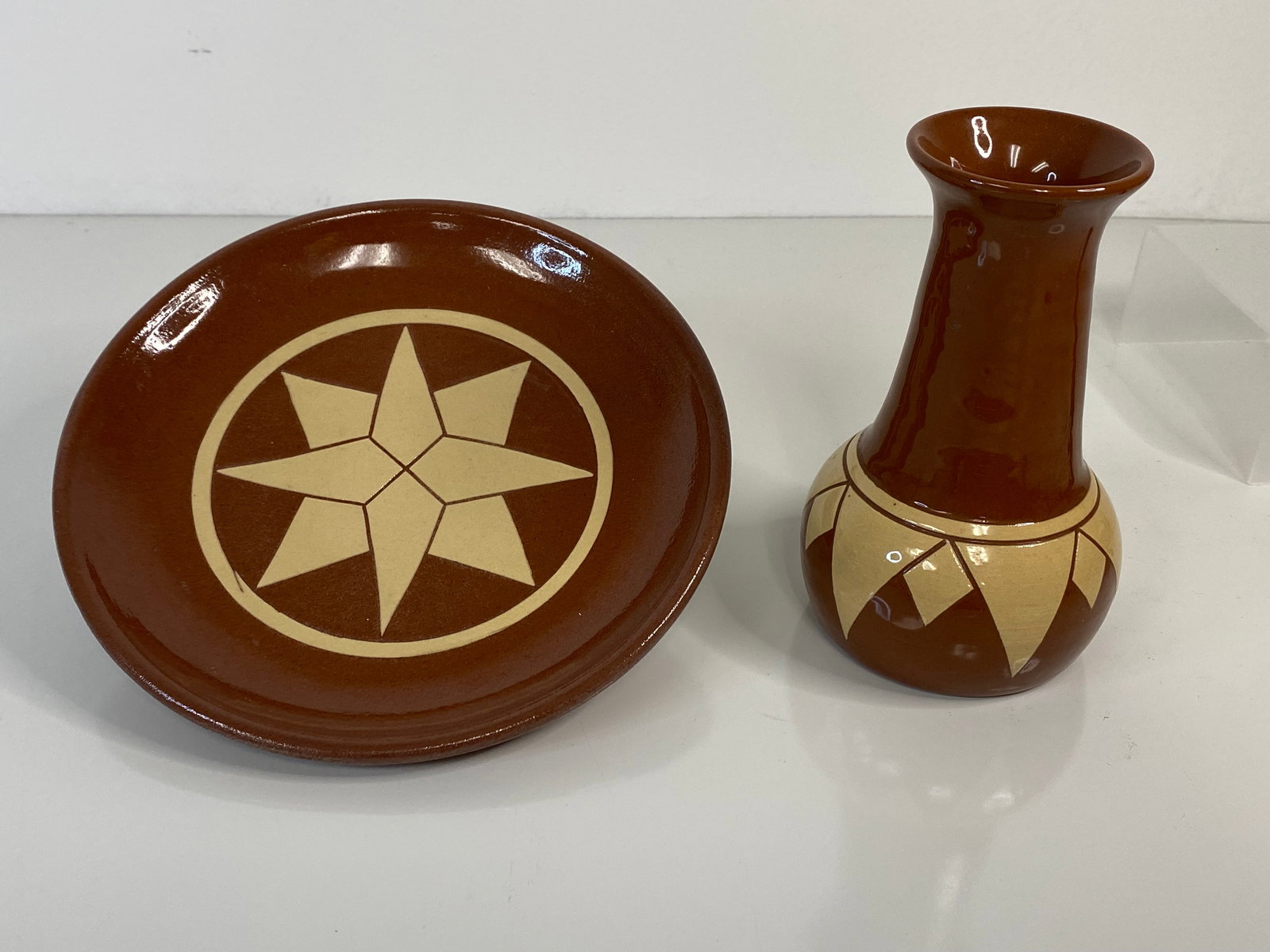 Pine Ridge Pottery Sioux lot: 2 pieces including a plate 7 1/4" across and a vase 5 1/2" tall. Vase signed E Irving and Plate signed B Fallert
