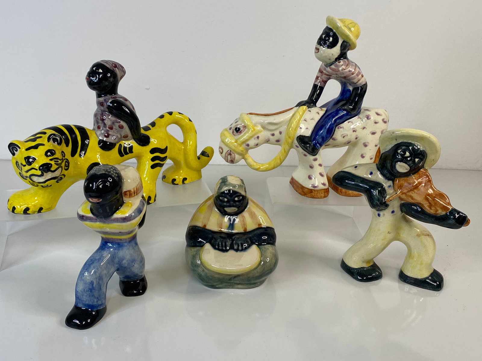 Shearwater Figural Lot Pottery: Fiddle Player at 6", Carrying cotton 5", Riding Horse 7 1/4" tall and 7" long, Woman on Tiger 8 1/2" long, last is a mammy cooking or cleaning. 23 3/4" tall.