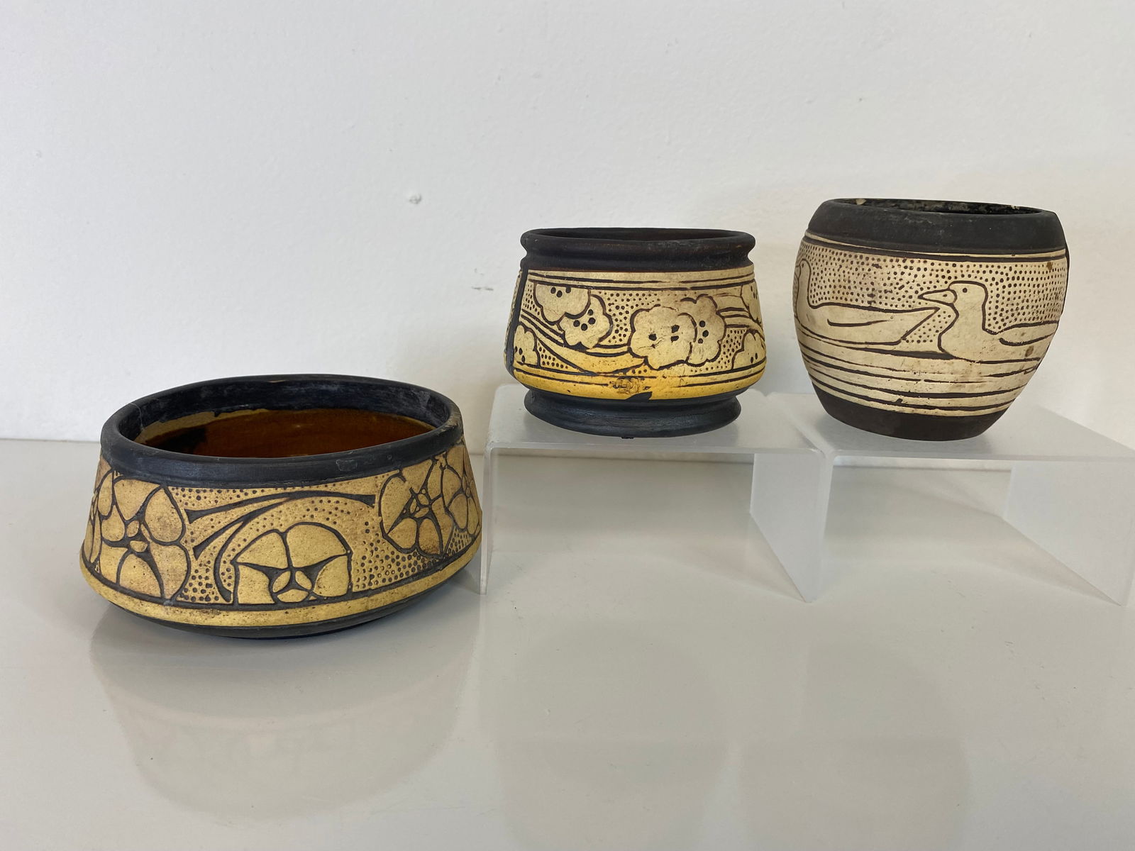 3 Pieces Weller Burntwood: The largest of the 3 measures 4 1/2" wide. Two have floral decoration and one has ducks.