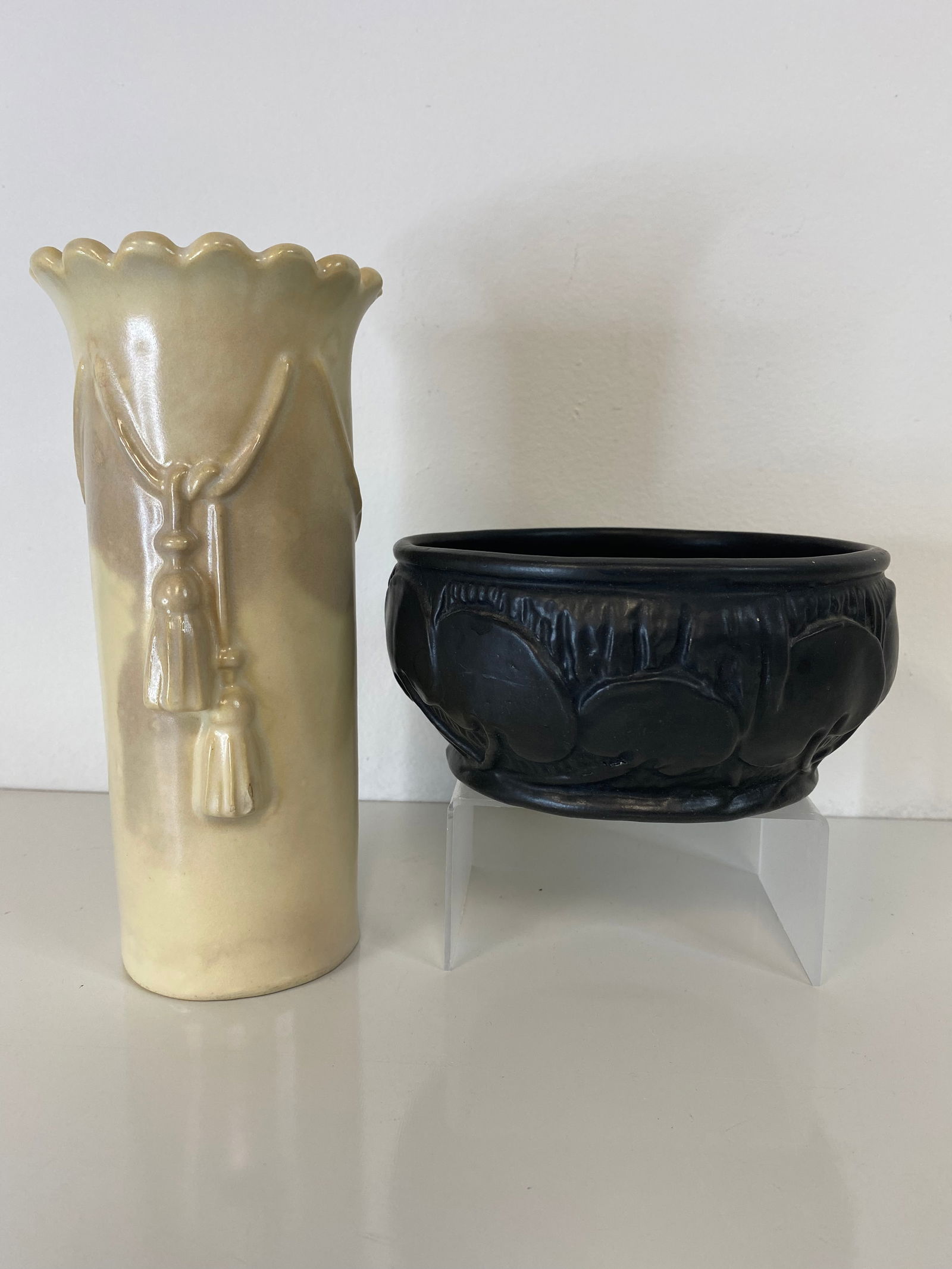 2 pcs Weller Pottery: This lot consists of a nice arts and crafts low bowl and a ivory vase with tassles.Bowl is 6" wide and vase is 7 3/4" tall