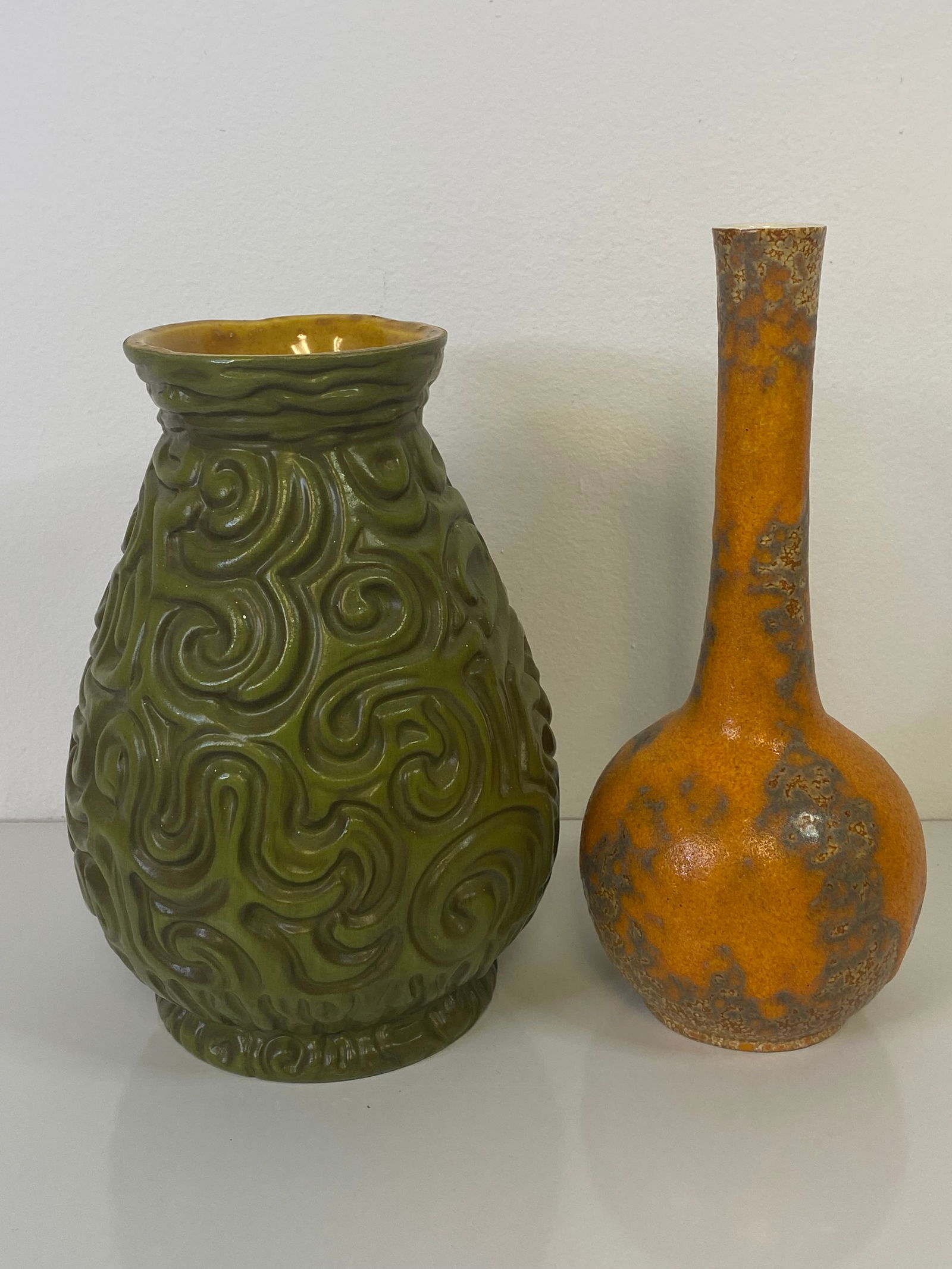 2 Haeger Pottery Vases: 1 more of the Tiki pieces this time in an olive green along with a very nice orange over brown bottle form standing 10" tall