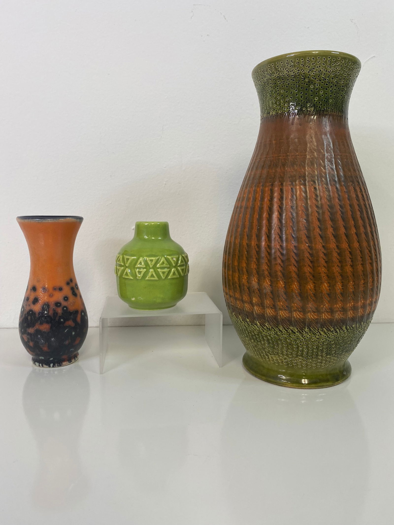 3 pieces West Germany MCM Pottery: Large impressive orange design over green measuring 10" along with a small green geometric vase and an orange with black dots