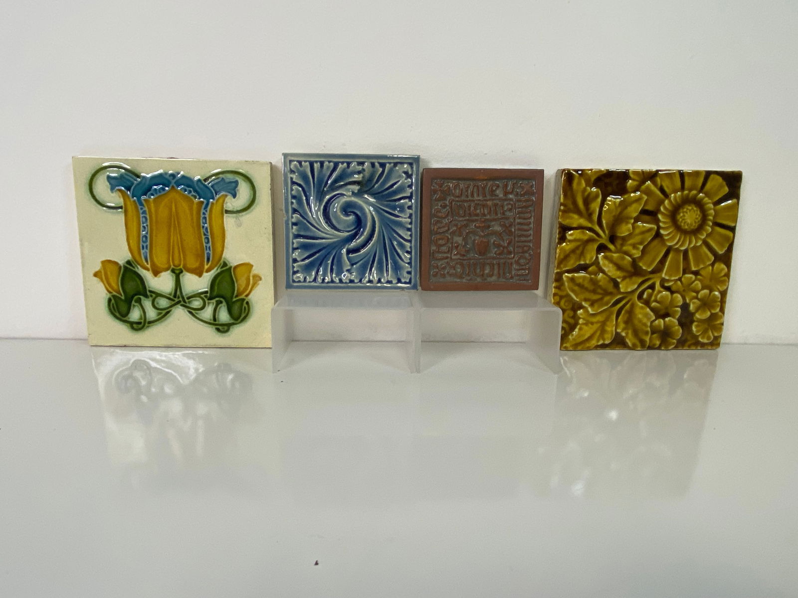 4 Tiles J.G.Low , moravian, and Trent: Great 6 x 6 tile with a greast art nouveau design, a Low tile of a blue floral, a copy of a moravian tile from the Isabella Stewart Cardner Museum and a Trent tile is yellow of a flower