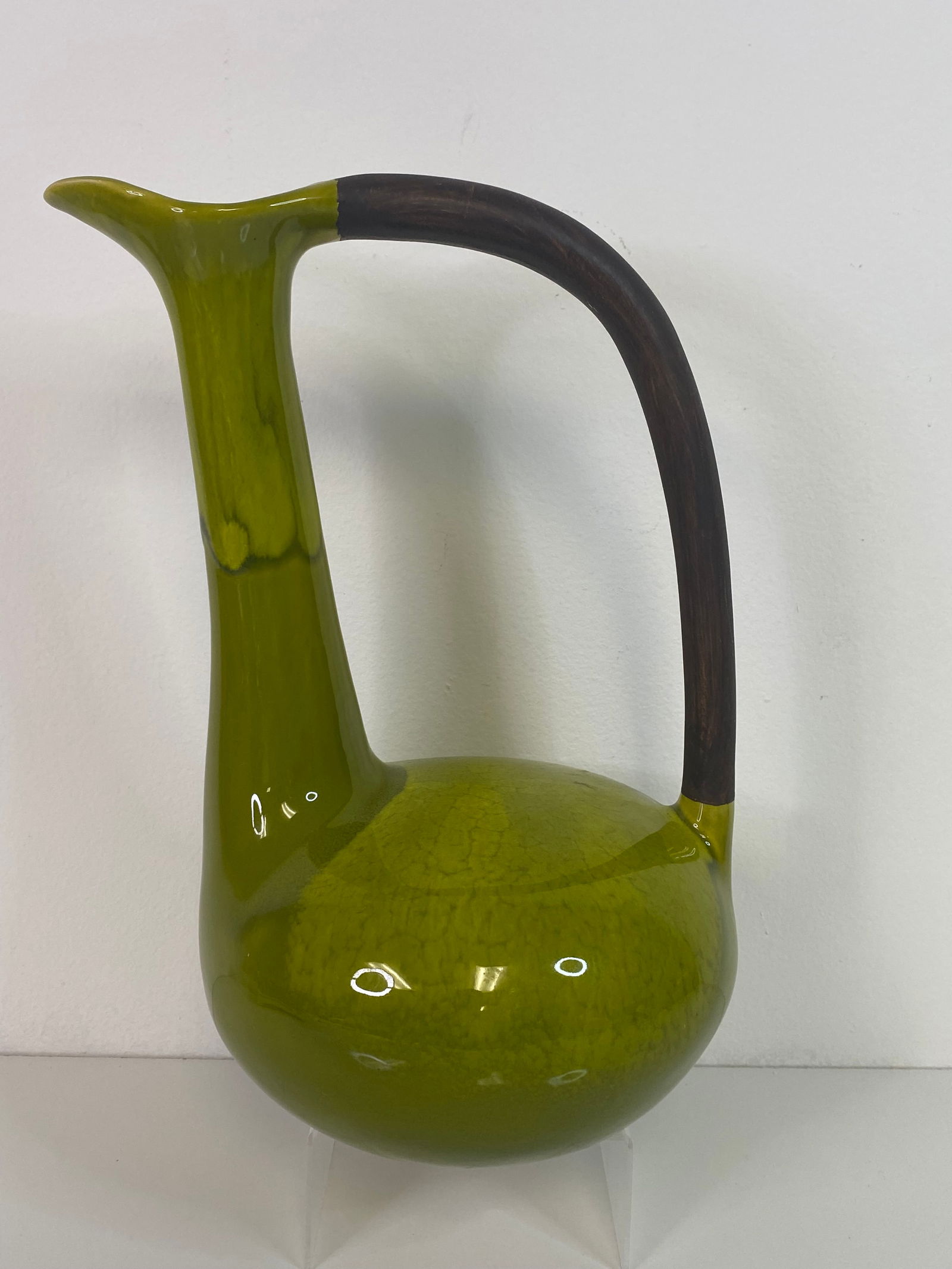 Large Green Pottery MCM: Pitcher of sorts in a rich olive green with some flowing glazes and painted bropwn handle a little ovber 12"