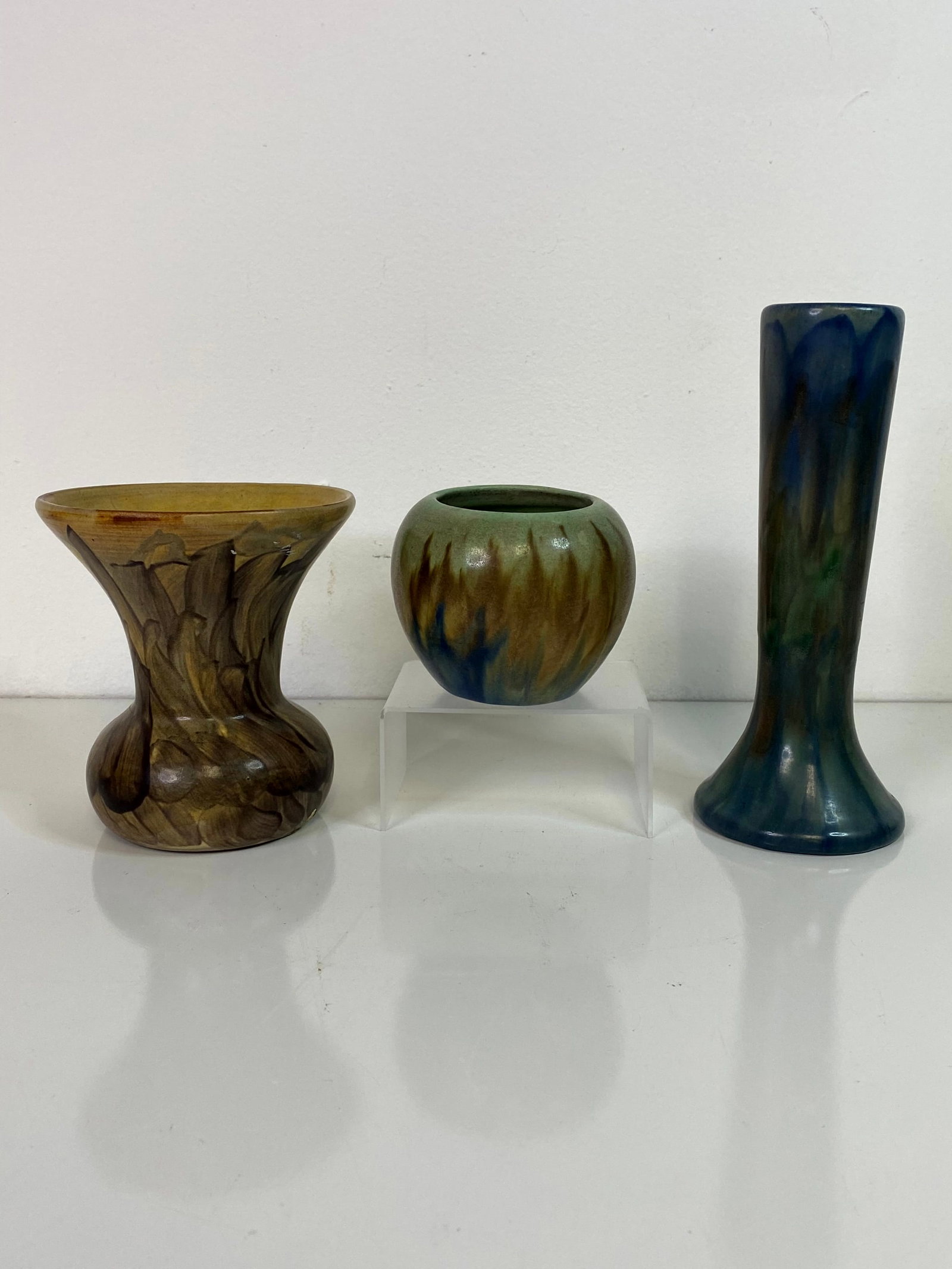 3 Peters and Reed Landsun: Taller bud vase in blues at 8" tall , a flared rim vase in browns at 5 1/8" tall and a smallvase in greens and blues at 3 1/4".