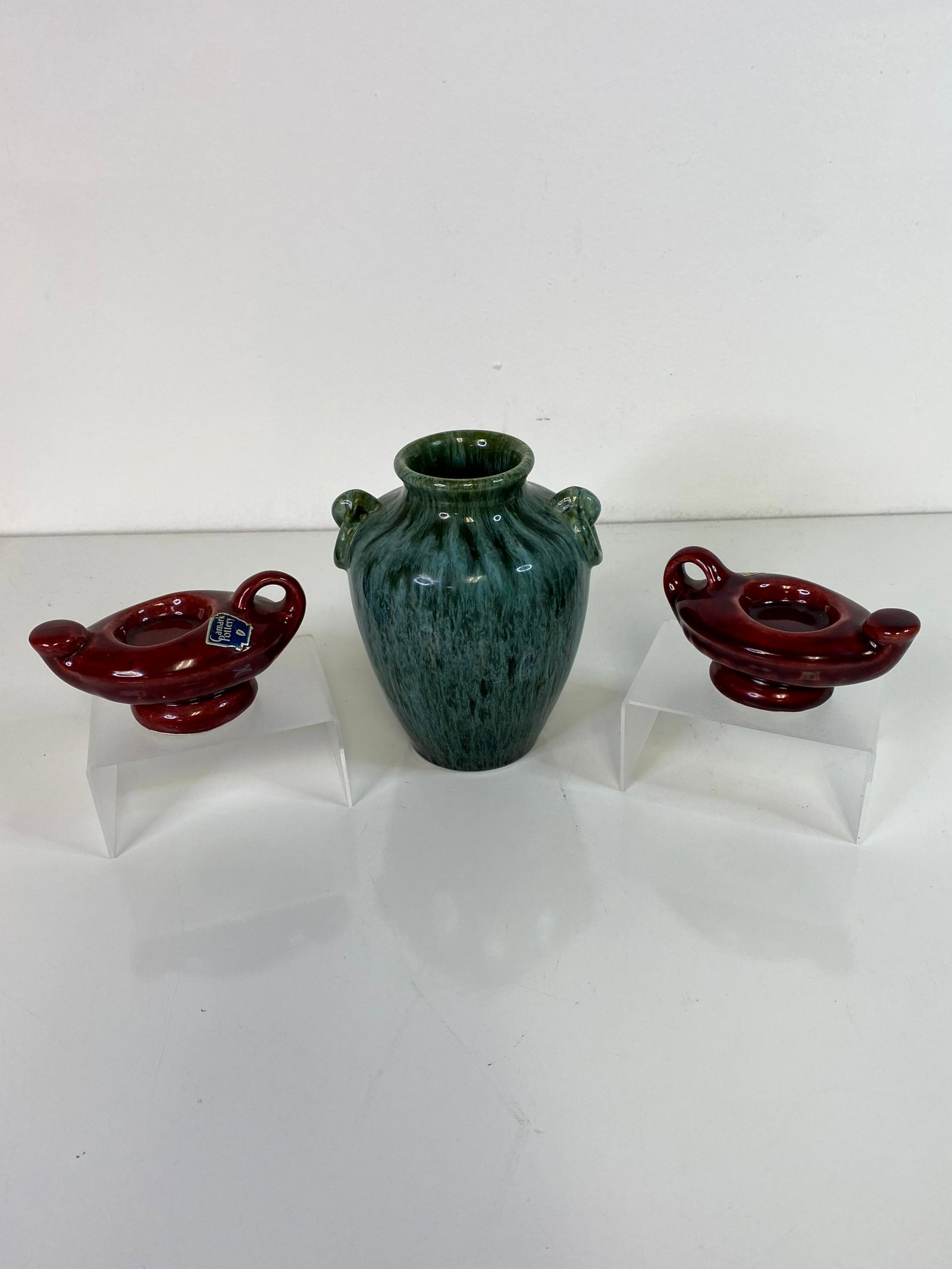 Camark Pottery Grouping: Taller Green vase stands 6" tall along with a pair of Genie lamp candle holders with the original sticker