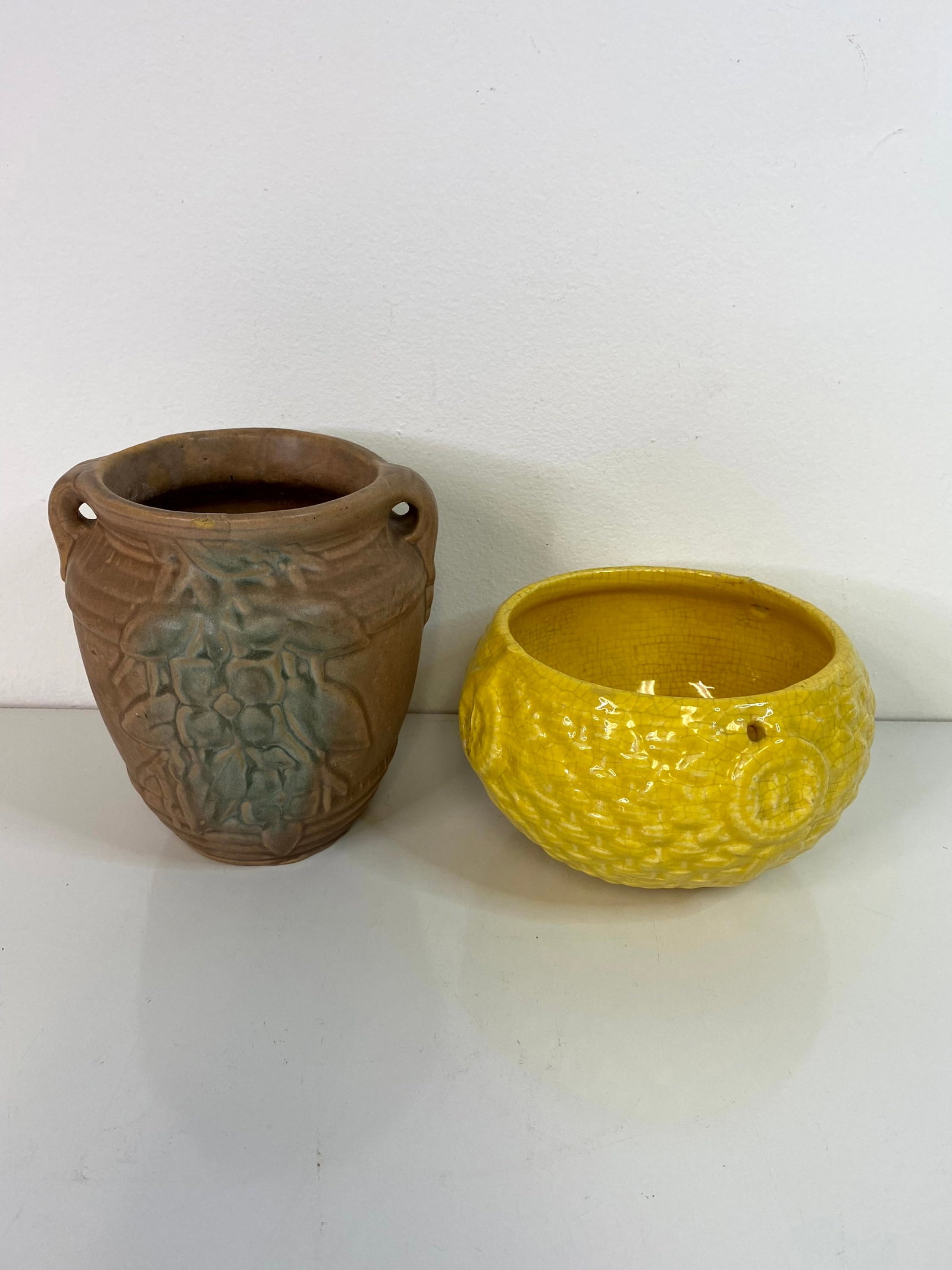 McCoy Pottery 2 pcs: Hanging basket in the Basketweave pattern and a holly and berries vase standing 7 1/8" tall.