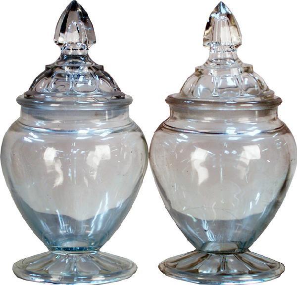 PAIR OF MEDIUM SIZED GLASS CANDY JARS: Measures: 11"H Pair Of Medium Sized Glass Candy Jars PROVENANCE: Richard Greenburg of Wilmington (1948 - 2019), enlisted in the USAF mostly overseas. Chip was an F15 Line Chief stationed at s NATO bas