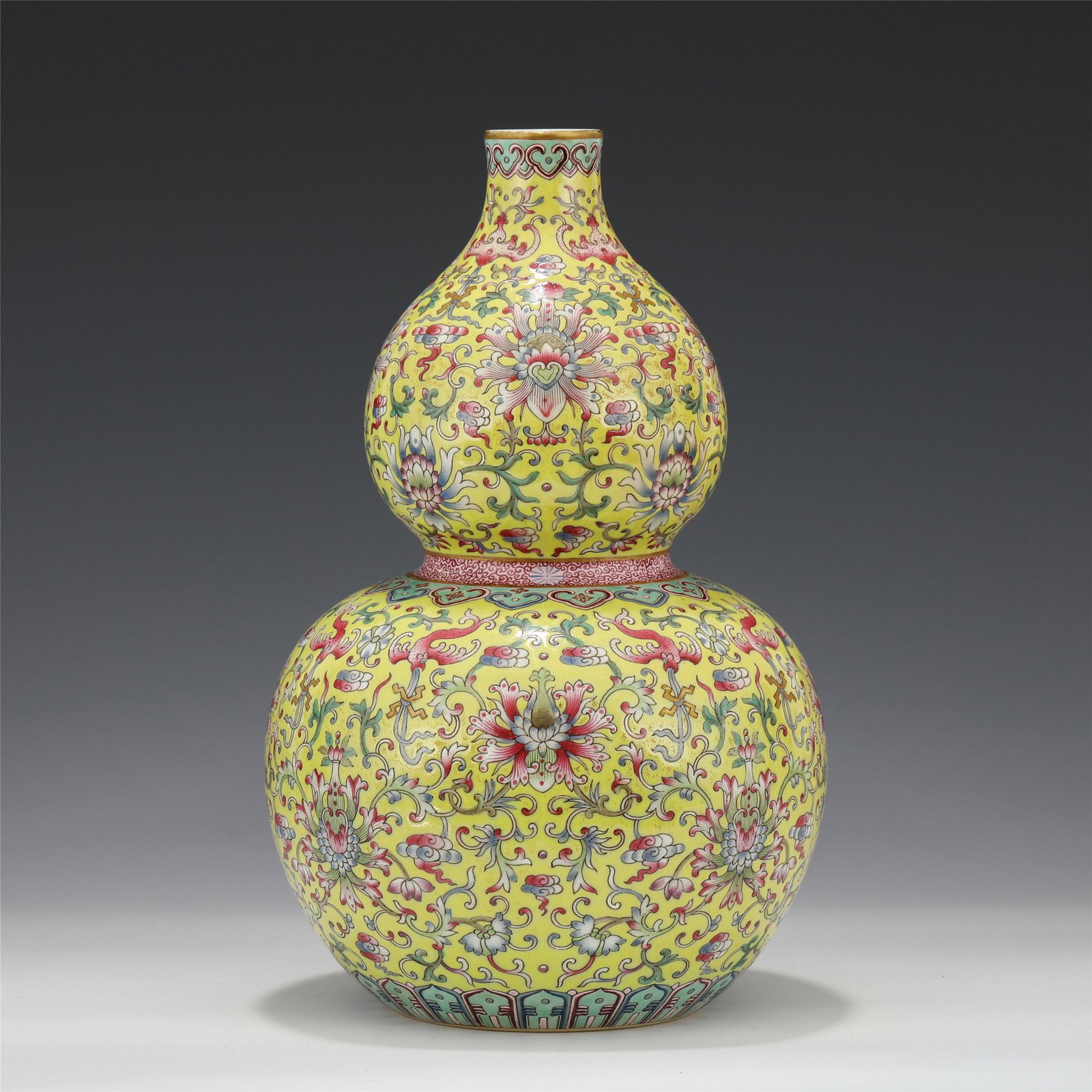 A CHINESE FAMILLE ROSE PORCELAIN FLOWER GOURD SHAPED VA: A Chinese famille rose porcelain flower gourd shaped vase Qing dynasty Qianlong period 25.4 cm H x 16 cm Diam Because of its homophonic sound "Fu Lu", the gourd has the meaning of "Fu Lu Wan Nian". Th
