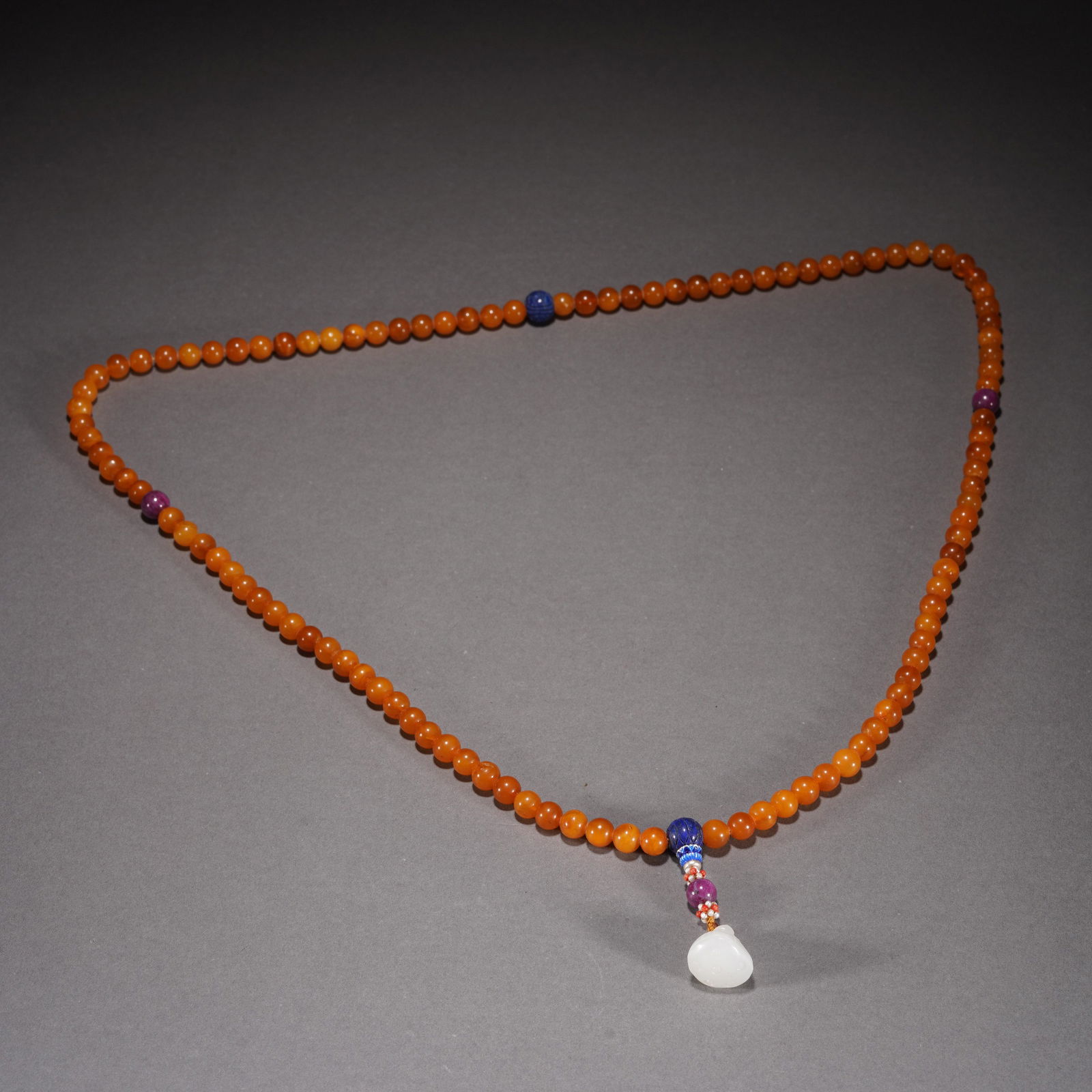 AN AMBER BUDDHIST BEADS (1 of 8)