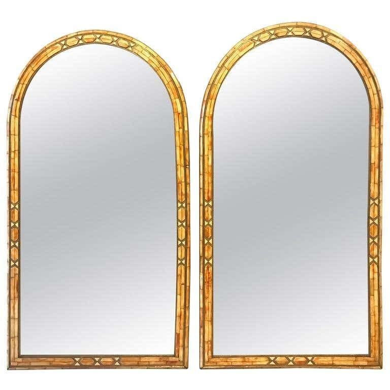 Hollywood Regency Bone & Brass Inlay Wall Mirror, Pair: Mid Century 1950's Wall console or pier mirror palatial Hollywood Regency fashioned, pair. With generous pieces of orange camel bone set into a frame of brass, these uniquely constructed mirrors exude