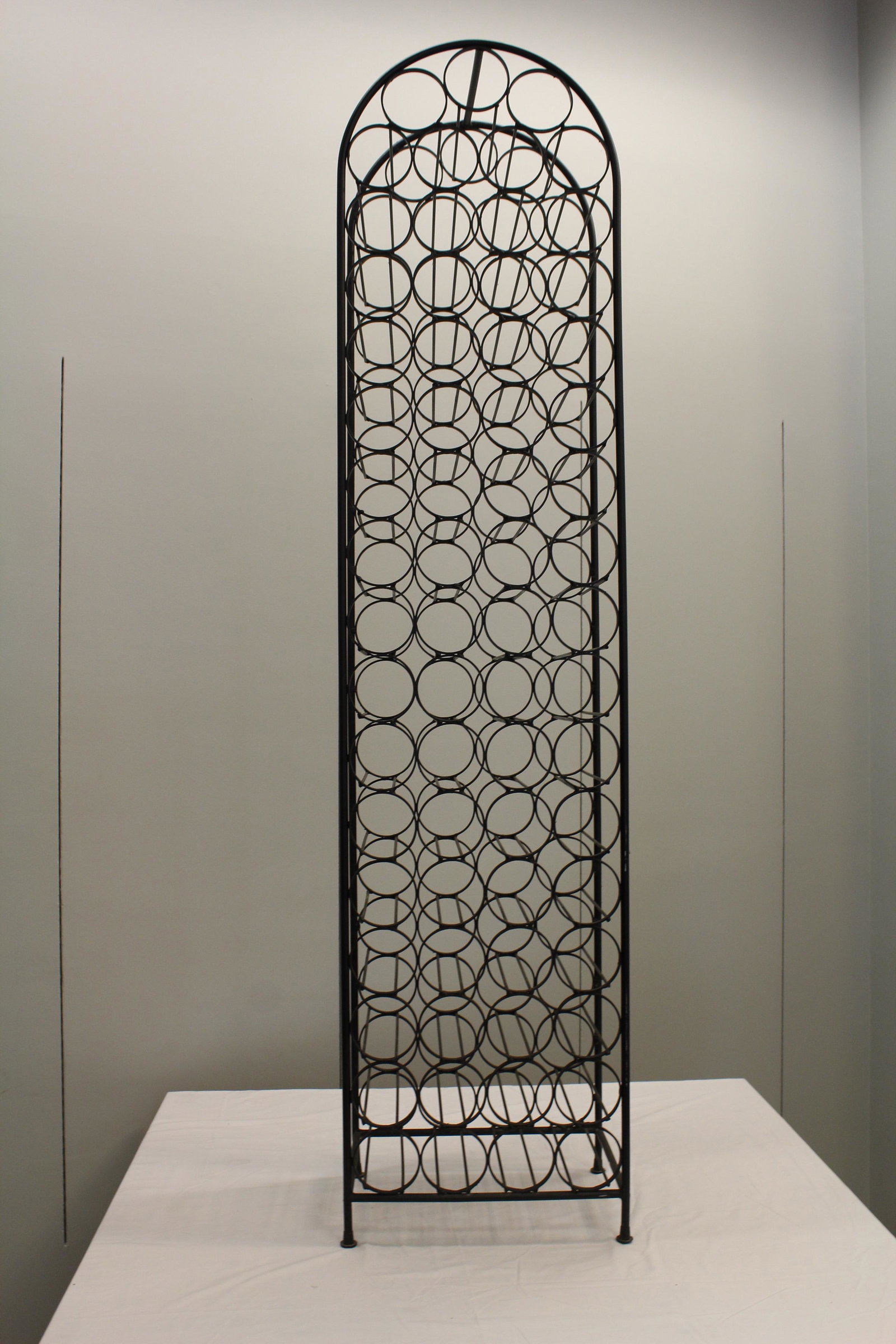 Contemporary wrought iron wine bottle holder: CONDITION NOTES: Holds 67 Bottles of Wine MEASUREMENTS: 53" x 13 1/2"