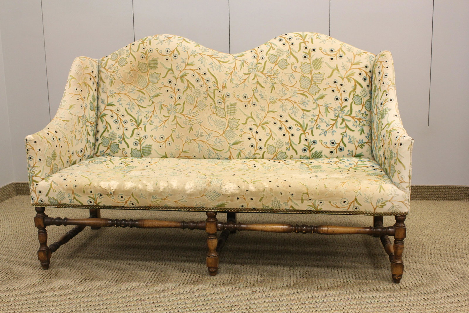 William and Mary Style Upholstered Settee: Double arched back, sloped arms, carved legs