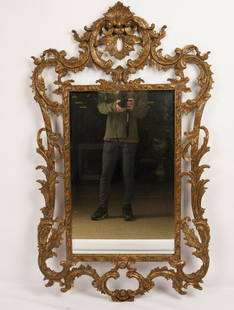 Carved and Gilt Wood Louis XV Style Mirror: Typical form; carved and open frame depicting a foliate and scrolled border