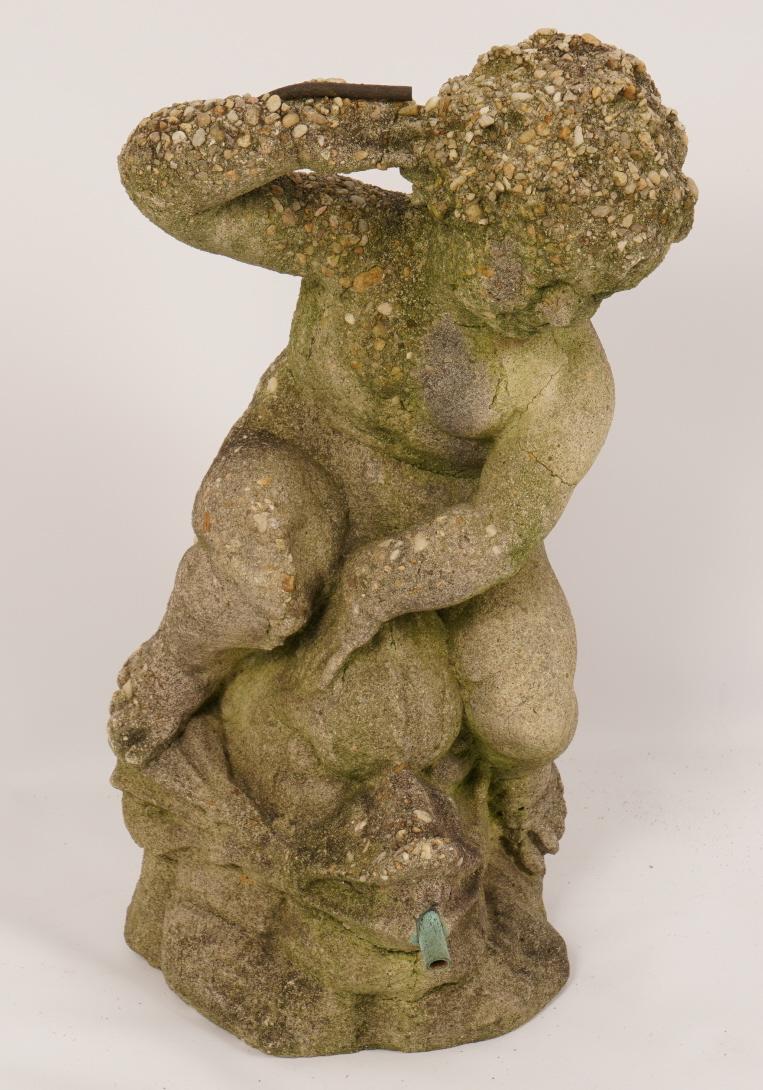 Cast Stone Garden Fountain: Depicts a putti resting on a sea monster