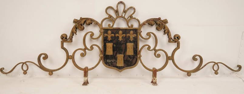 French Wrought Iron Gate Cornice: Elaborate wrought iron design centering a family crest on both sides.