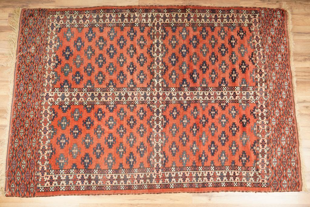 Hand-Knotted Turkaman Style Area Rug: Having four centralized squares with interior decoration surrounded by a geometric border. In green, umbers, white and blue.