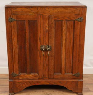 American Two Door Ice Chest: Constructed of golden oak with raised panels. Zinc lined base with original brass hardware.