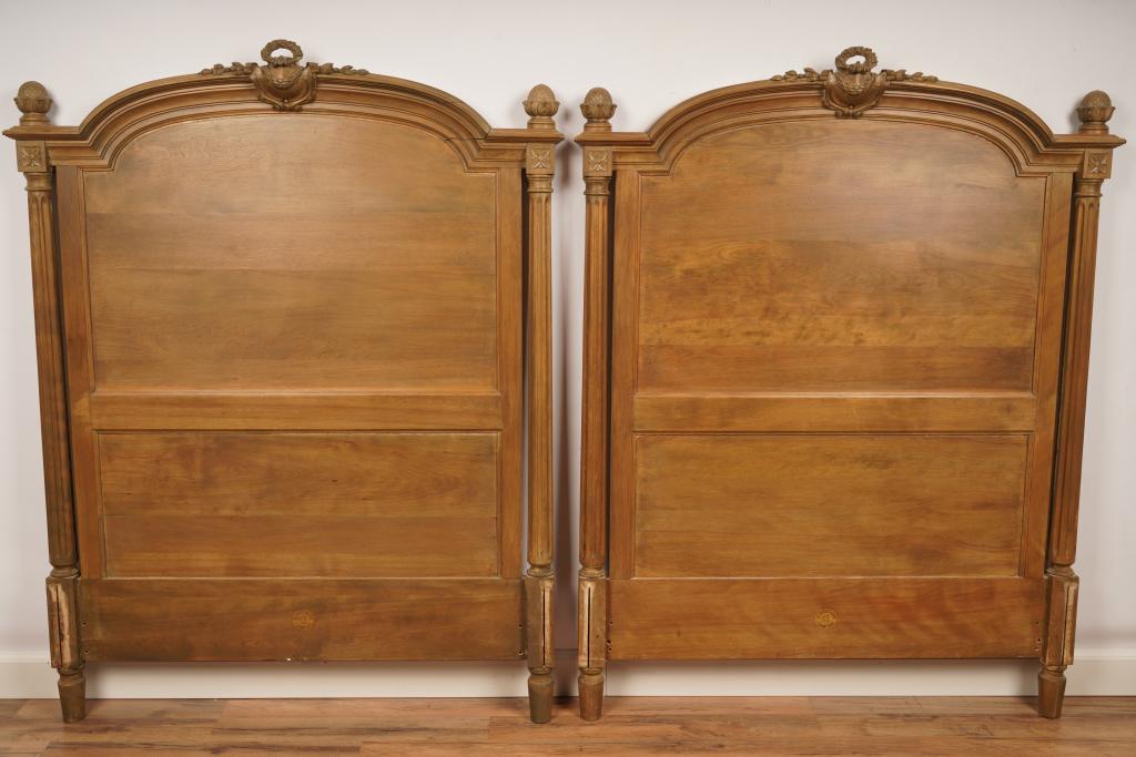 Berkey & Gay French Louis XVI Twin Headboards: Finely carved bleached wood headboards flanked with fluted columns topped with a garland wreath ornament.