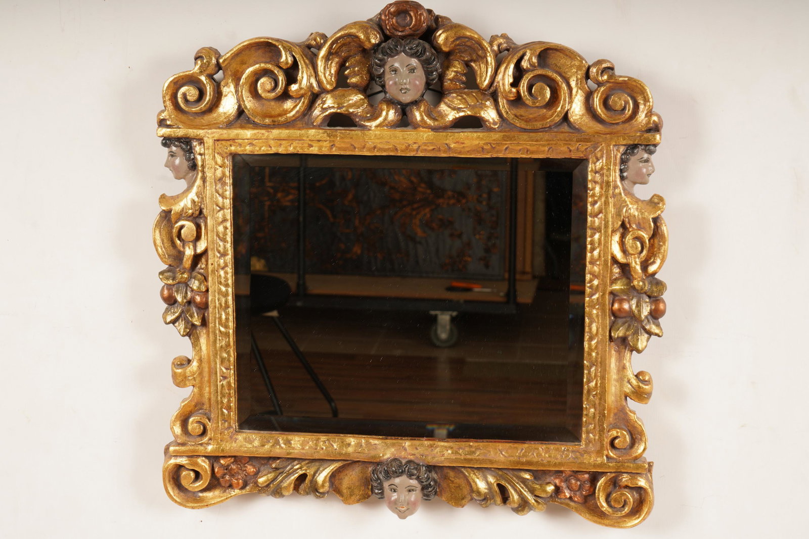 Antique Spanish Baroque Gilt Wood Mirror: One (1) mirror in gold gilt frame with a girl's face at the top and botton of the mirror and also on the left and the right facing sideways. H 24" x W 24".