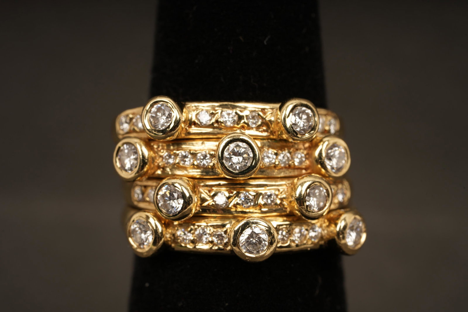 14k Gold Stacked Diamond Ring 8.94g: Marked MCD 14K. Contains 32 Total Bezel Set Diamonds, 10 roughly 2.25mm dia, 22 roughly 1.25mm dia. H .9 W .75 D .5 Weight 8.94 Grams TW