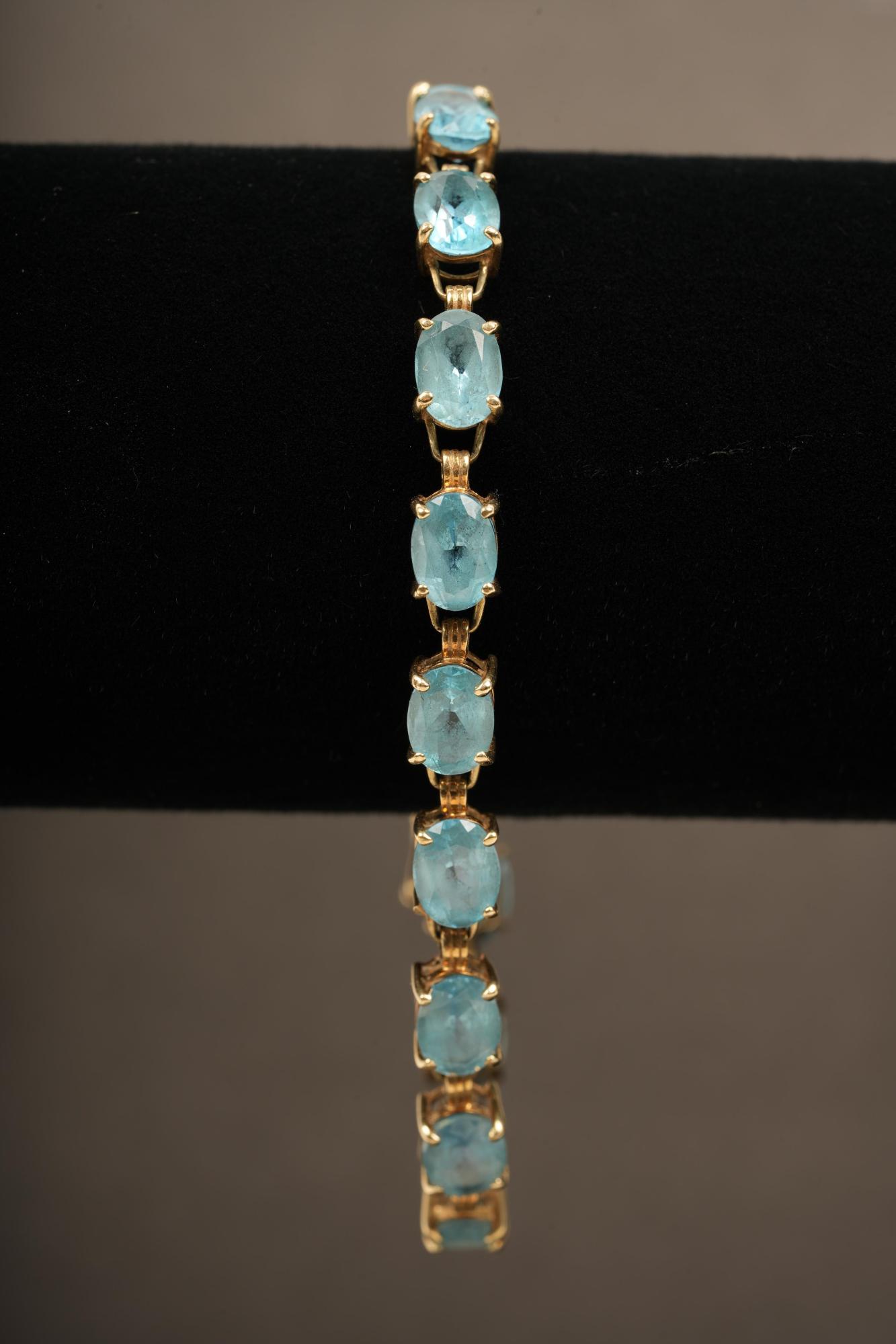 10K Gold London Blue Topaz Bracelet: Marked 10k. 7.25in Open. 2.25in Inside Diameter Closed. Box Link. H 7.25 W .2 D .25 Weight 8.38 Grams TW