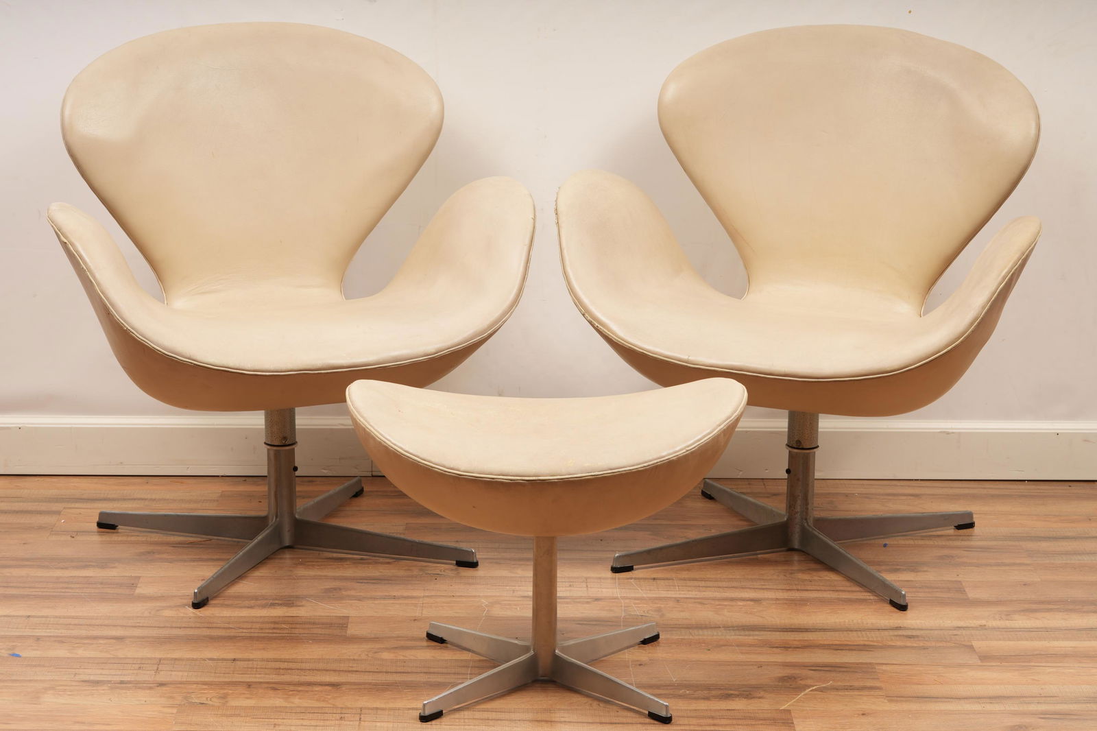 Pair Fritz Hansen Swan Chairs With Ottoman: From a Potomac, MD estate. Made in Denmark - tag intact. H 32.5 W 30.5 D 26 Soiling, Minor Tears/Abrasions. Fritz Hansen, a Danish carpenter, founded his own furniture company under his name in 1872.