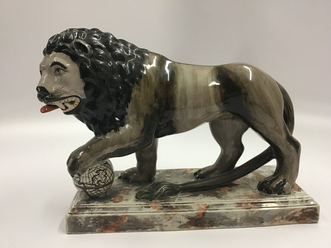 Staffordshire Lion on Orange/Silver Lustre Base C 1820: One paw resting on the globe of the world representing the British Empire
