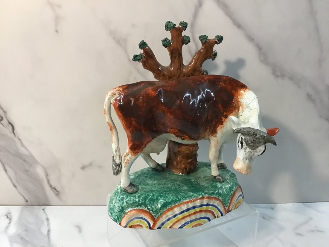 Sherratt Rainbow Cow Staffordshire Figure With Bocage: Rare example with unusual bocage decoration and vibrant base and decoration under base. Good colors. Neck repaired.