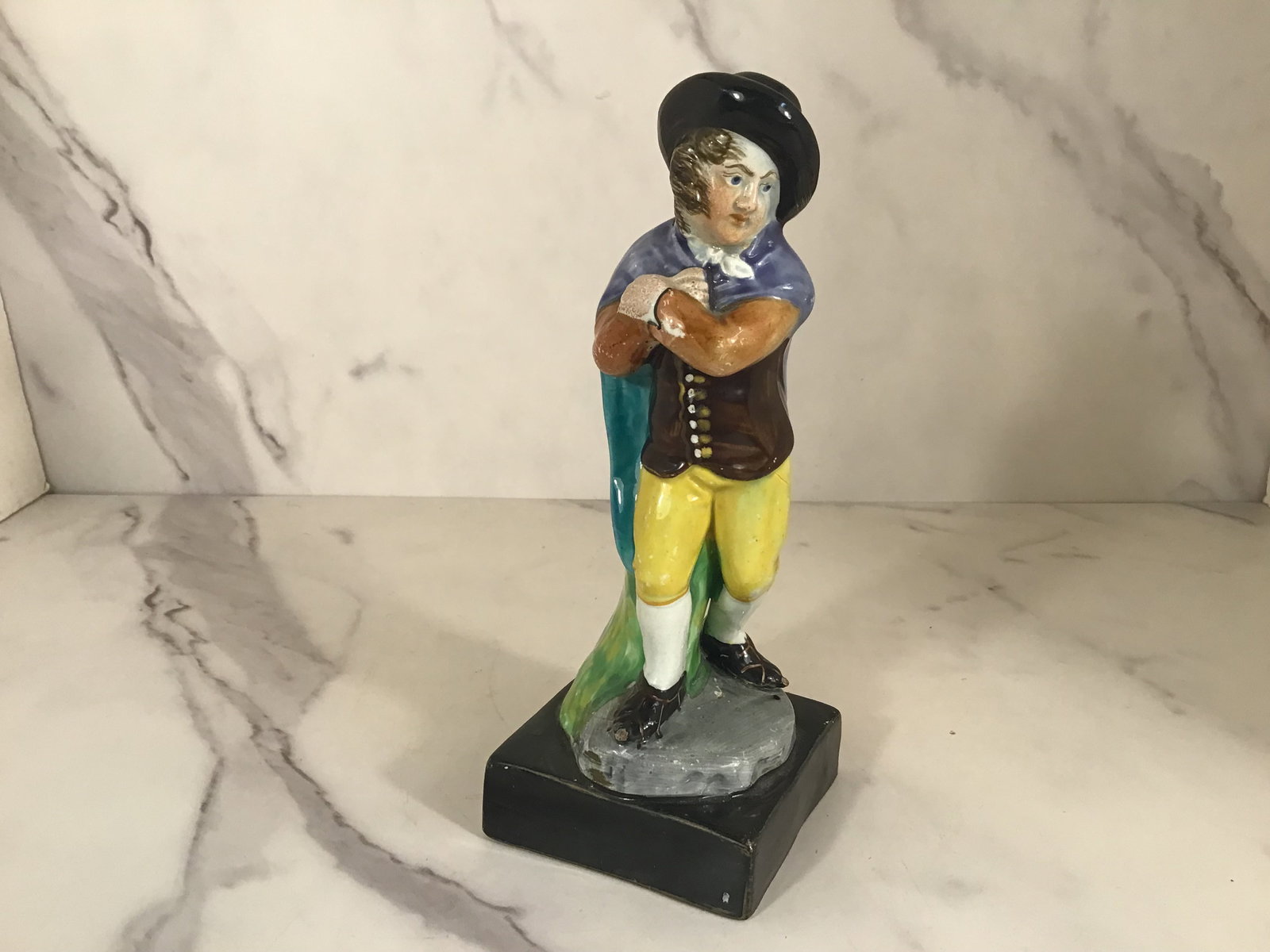 English Pearlware Staffordshire Figure of WINTER: 7 inches tall. Raised on a black base.