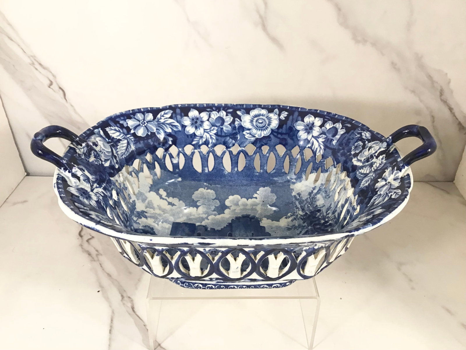 English Dark Blue and White Stevenson Staffordshire Arcaded Chestnut Basket: 11" wide; heavy floral decoration with a center scene of a woman in front of a castle.