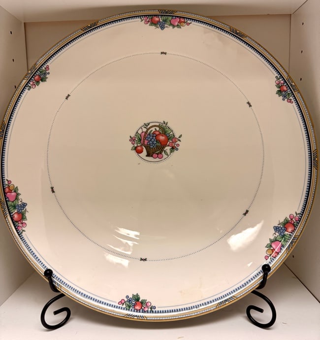 BONE CHINA CHRISTOPHER STUART 13" CAKE PLATE Y1008 "FRUIT BASKET THEME": Up for auction is a beautiful Christopher Stuart 13" cake plate, pattern number Y1008, crafted from fine bone china. This elegant plate features a central motif of a basket filled with an assortment o