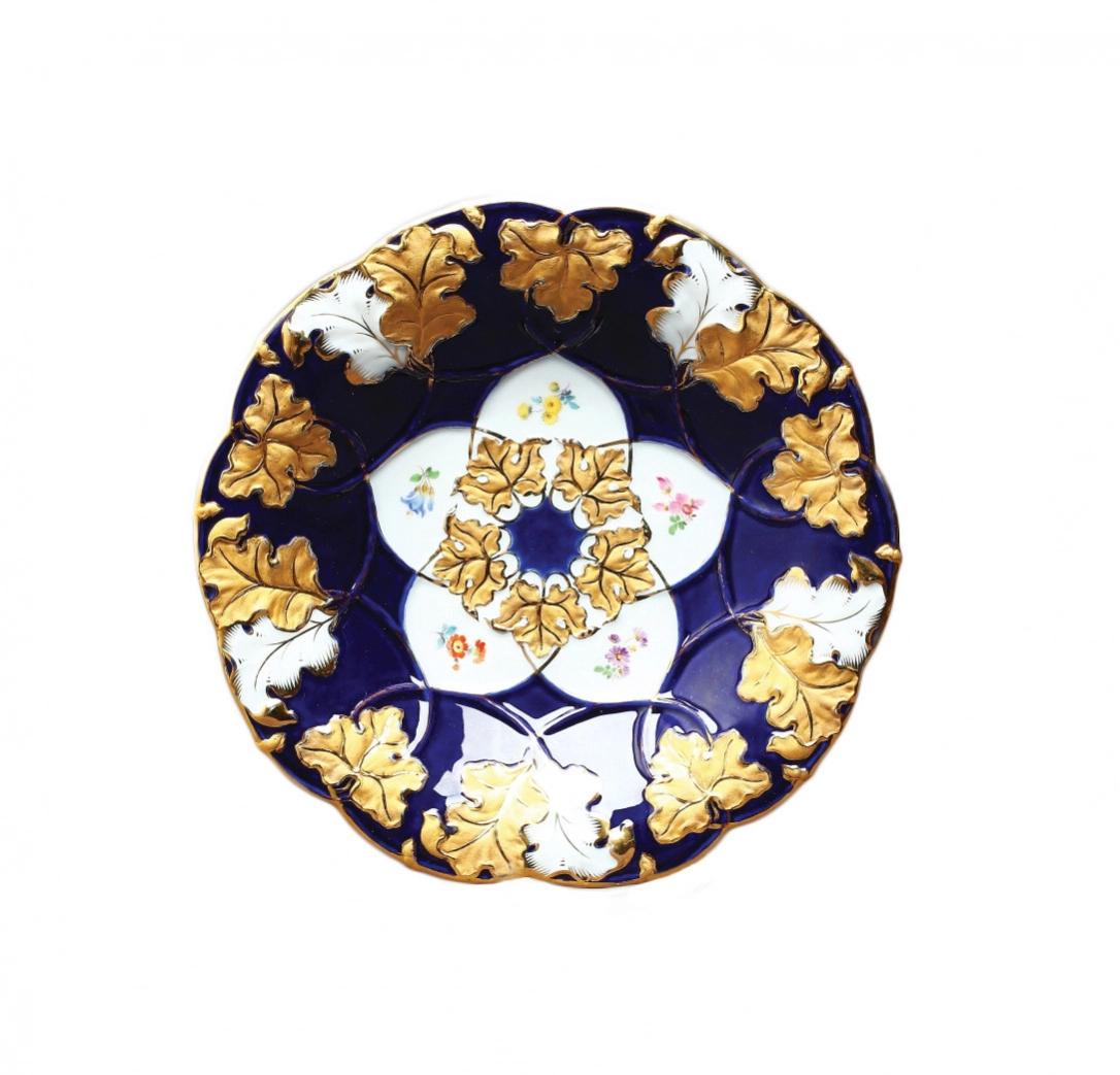 Decorative Dish Meissen: Decorative Dish Meissen, with a gilded pattern on a cobalt background and with a flower silhouette in the middle. Stamp of the Meissen manufactory 1934-45. Diameter 28 cm.