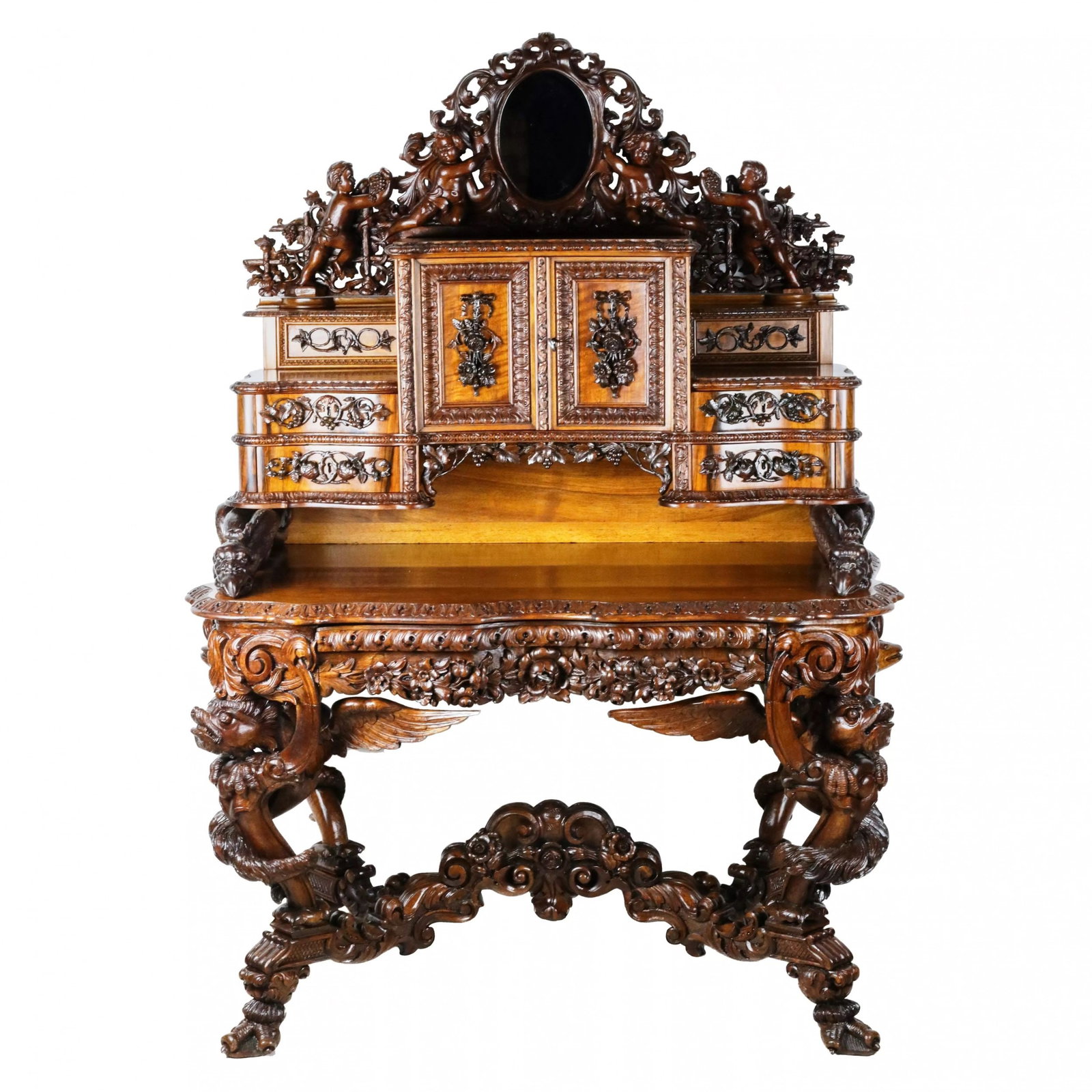 Magnificent carved bureau table in the Baroque neo-Gothic style. France 19th century.: Magnificent carved bureau table in the Baroque neo-Gothic style. The terraced structure of work surfaces, with two-tiered storage units and a double-door cabinet, is topped with a Baroque cartouche wi
