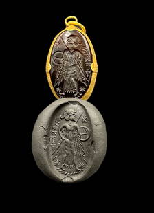 Ancient Greek Garnet Stone Intaglio Mounted In Gold As Pendant: This ancient Greek garnet stone intaglio, mounted in gold as a pendant, features a finely carved design that reflects the artistic skill of the period. The rich garnet stone and luxurious gold setting