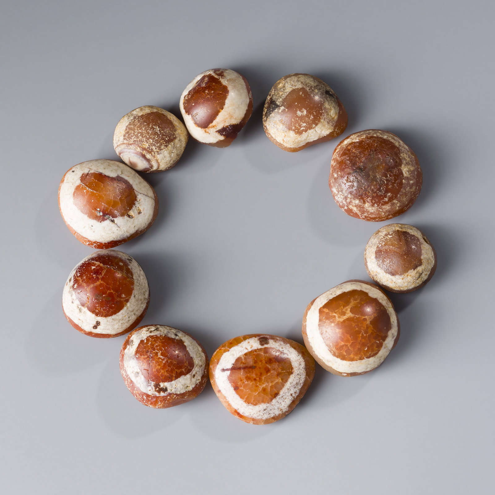 Sino-Tibetan Antique Etched Carnelian "Luk Mik" Magic Eye Beads [10pcs, 62g]: A set of 10 old etched carnelian beads known as Luk Mik or "Magic Eye" beads, weighing a total of 62 grams. Originating from the Sino-Tibetan cultural sphere, these beads are believed to offer protect