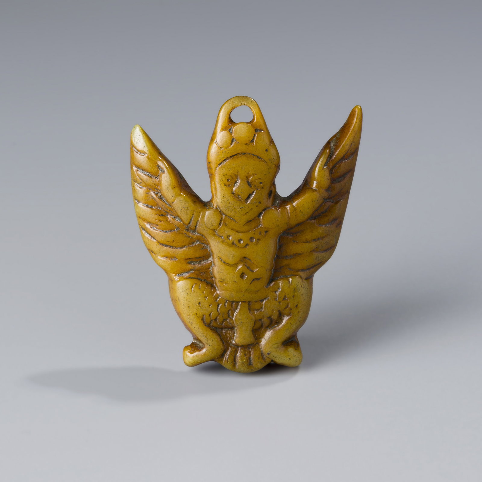 Tibetan Antique Bone Carved Garuda Talisman Amulet Pendant: An antique Tibetan pendant carved from bone, featuring the image of Garuda—a revered figure symbolizing protection and power in Himalayan traditions. Measuring approximately 4.8 x 5.8 cm and weighin