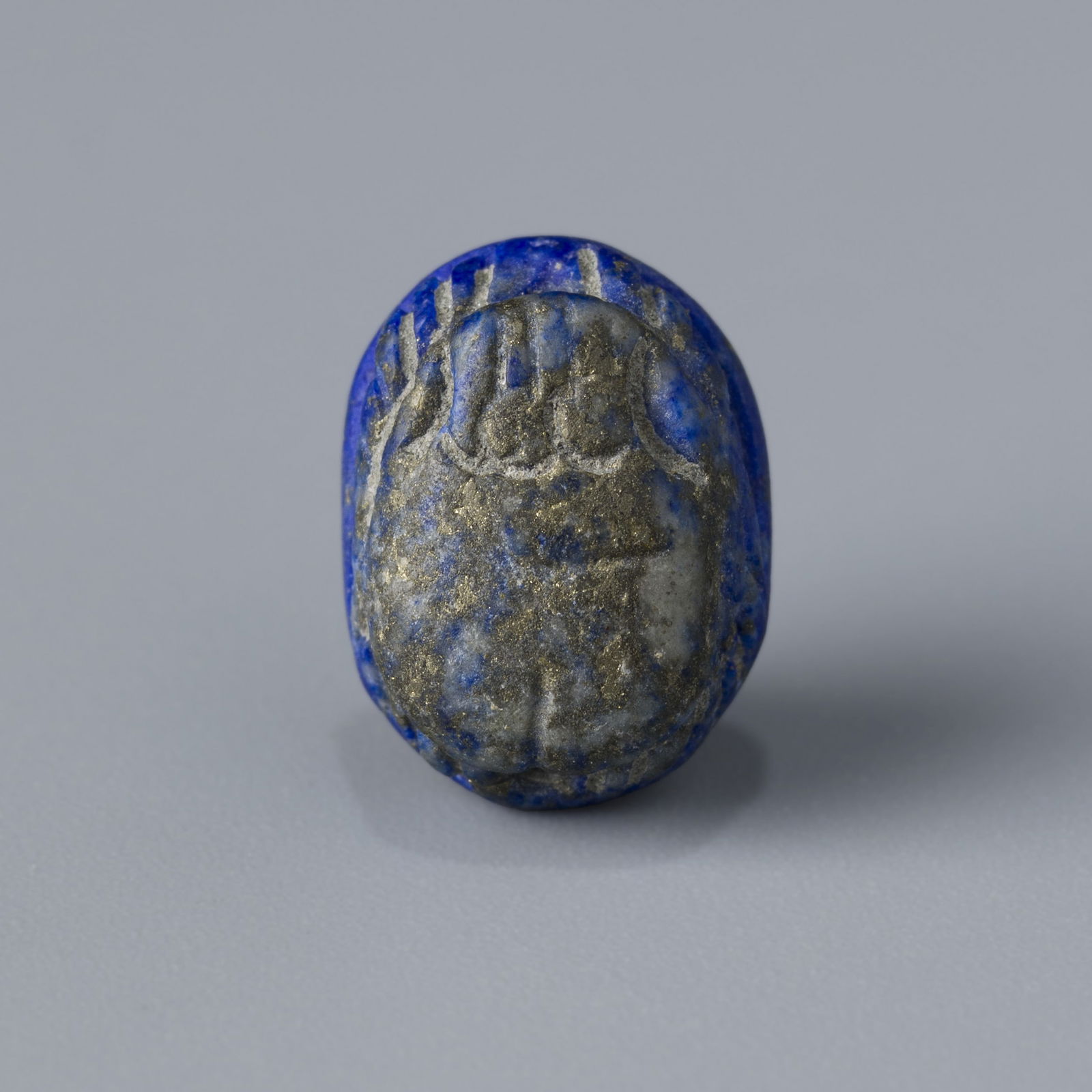 Egyptian Lapis Lazuli Scarab Seal Amulet Pendant: A small Egyptian lapis lazuli scarab carved as an intaglio stamp seal, also used as an amulet pendant. Measures 0.9 x 1.2 cm, weighs 1g. A finely crafted symbol of protection and authority in ancient