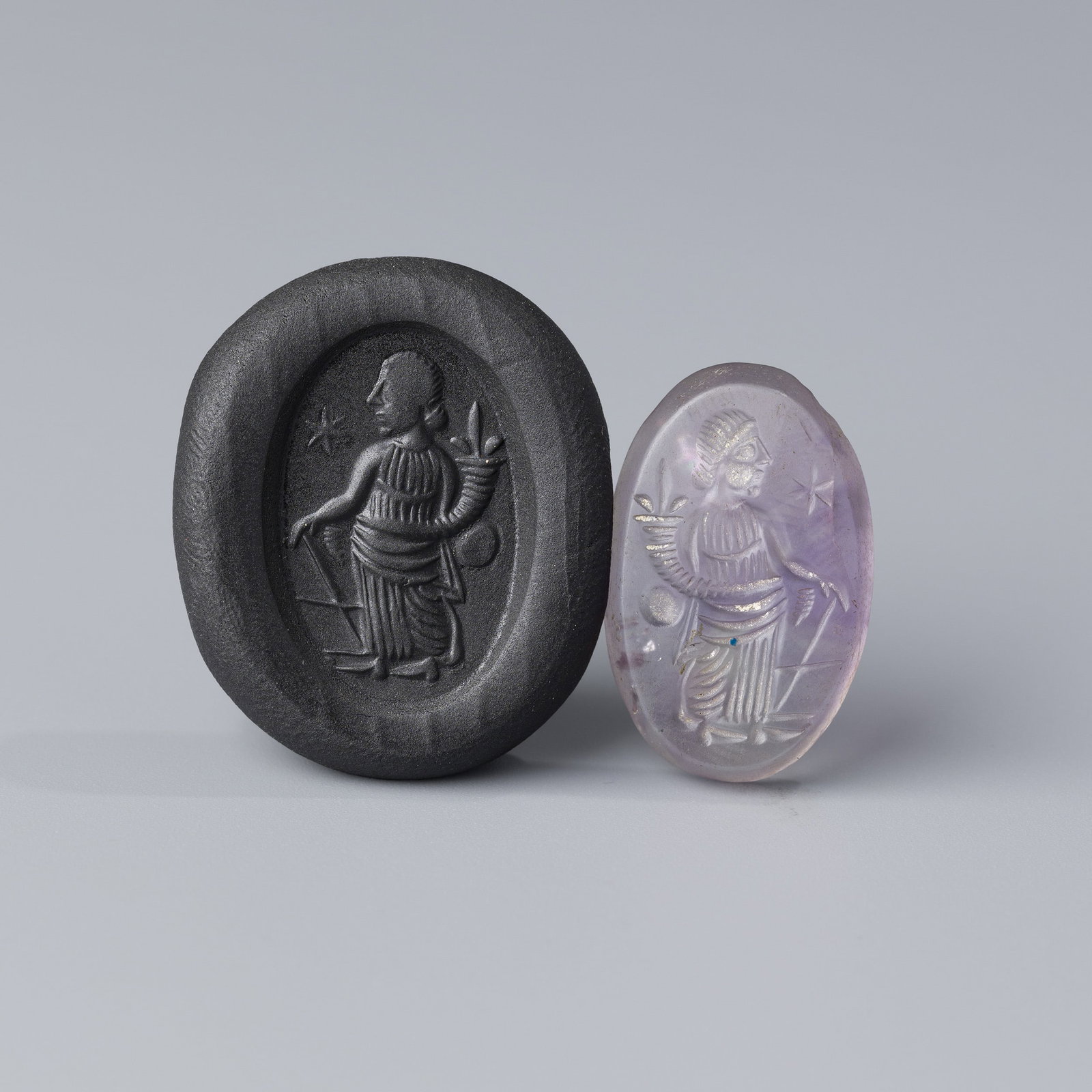 Roman Amethyst Stone Intaglio: A finely carved Roman intaglio made from rich amethyst stone.For clearer viewing, a wax clay impression has been made—photos of the imprint are included.Size: 1.6 x 2.6 cmWeight: 3 grams